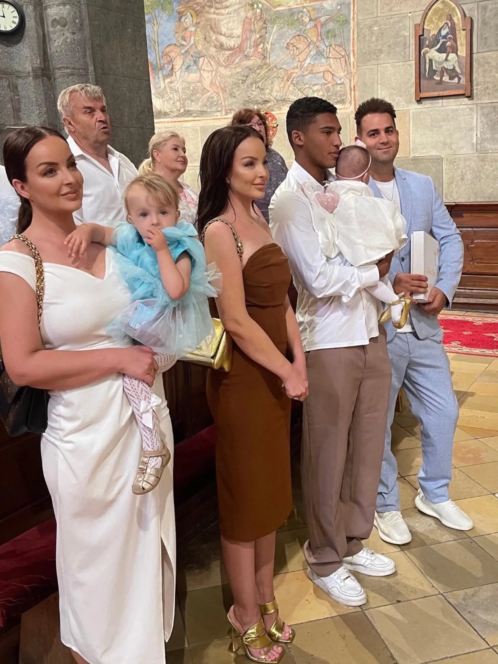 Krstná mama Ney Daniela s dcérkou Lindou na rukách a krstný otec Tomáš Stríž (vpravo), v strede Veronika Nízlová a Matúš Kolarovský s Neou na rukách