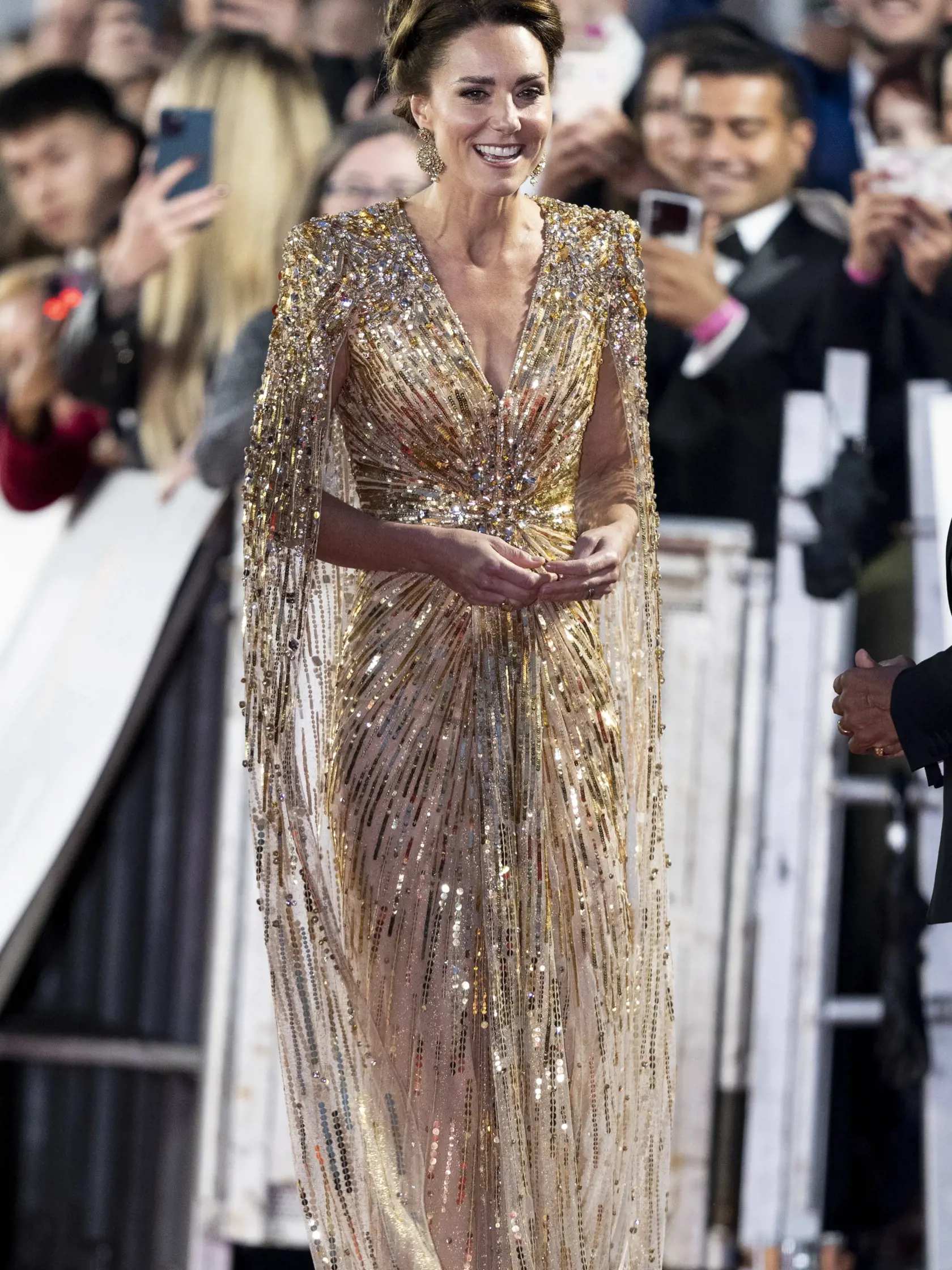 Vojvodkyňa Kate prišla v zlatých šatách od módnej návrhárky Jenny Packham v hodnote 3 200 eur a na sebe mala aj náušnice špeciálne vyrobené na mieru v hodnote 335 eur.