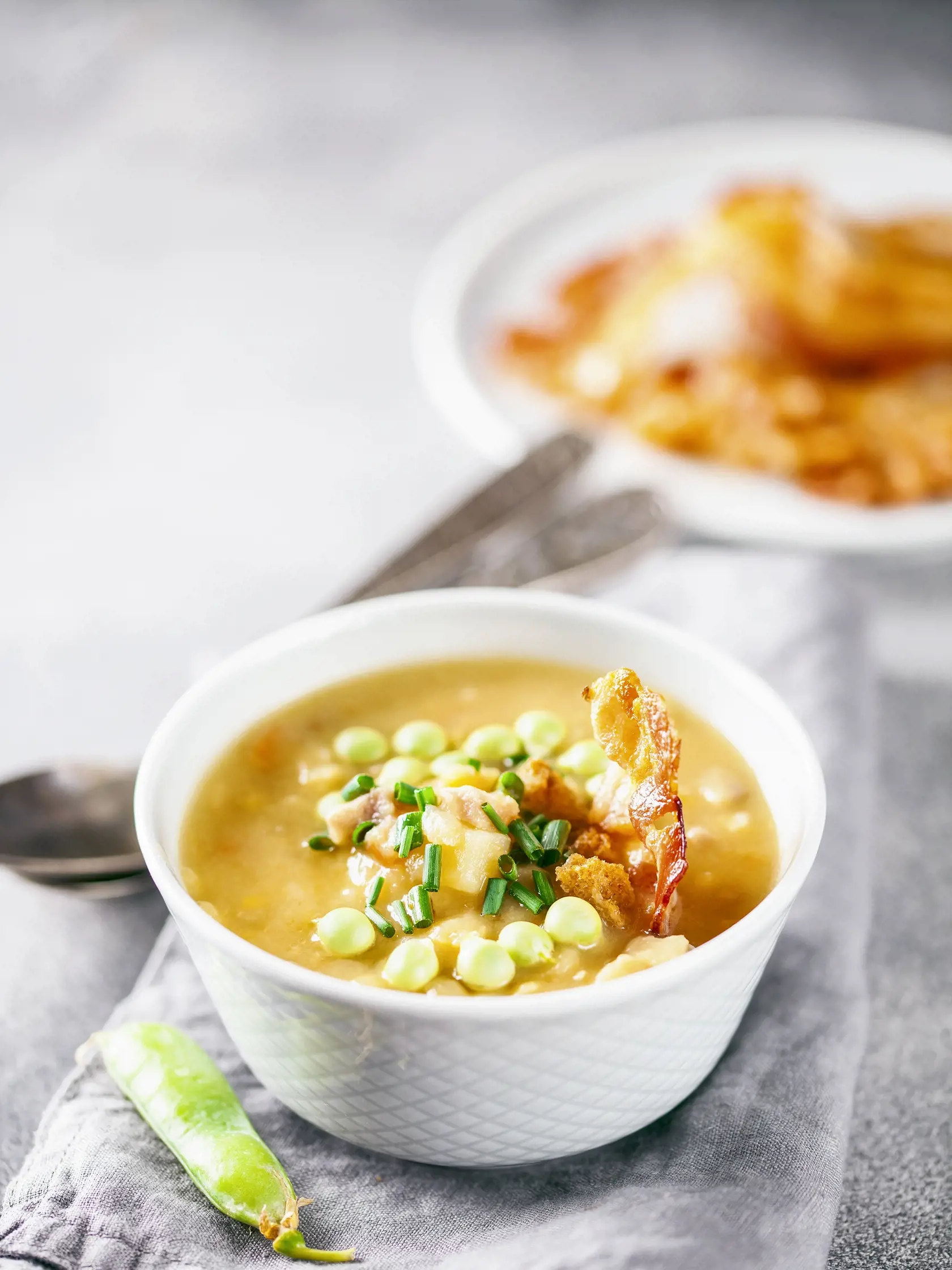 Pea bacon soup on a gray concrete background.