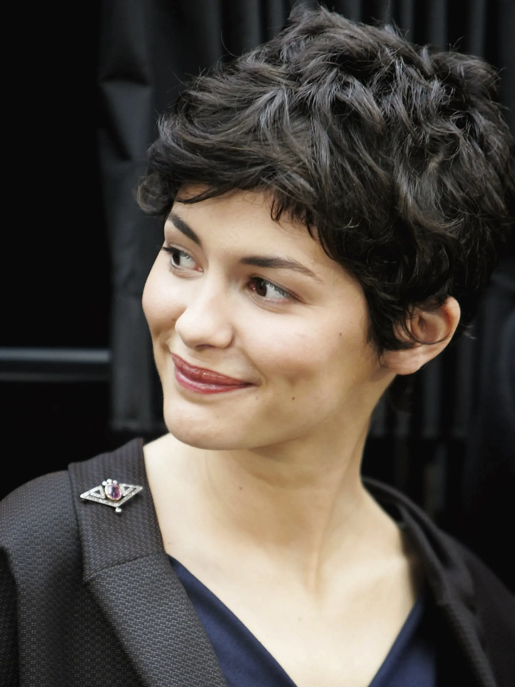 LONDON - MAY 16:  Actress Audrey Tautou smiles during a photocall for new film The Da Vinci Code at Eurostar's Waterloo International Terminal on May 16, 2006 in London, England. At the photocall a new Eurostar Train was named 'The Da Vinci Code' and it is attempting a new world record for the longest international non-stop journey with the cast of the film on Board. It will arrive in Cannes for the Premiere of the film.  (Photo by Chris Jackson/Getty Images)