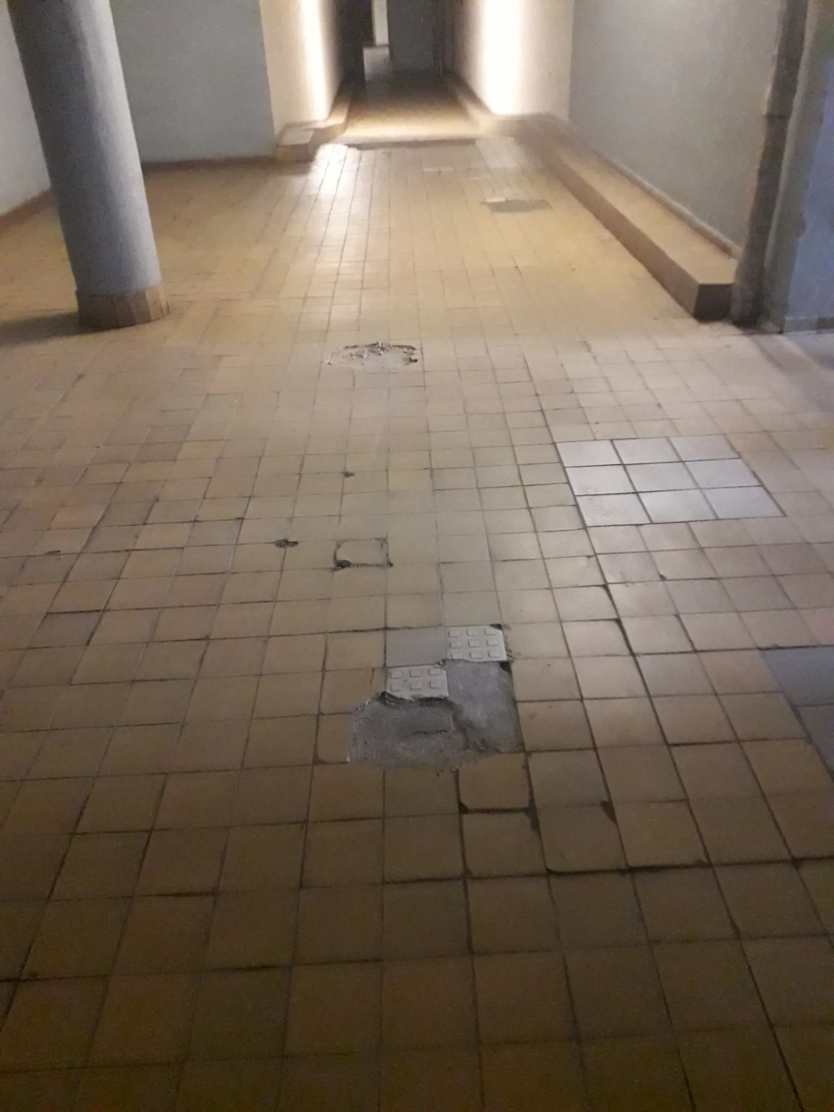 Dlažba je značne poškodená na viacerých miestach.
