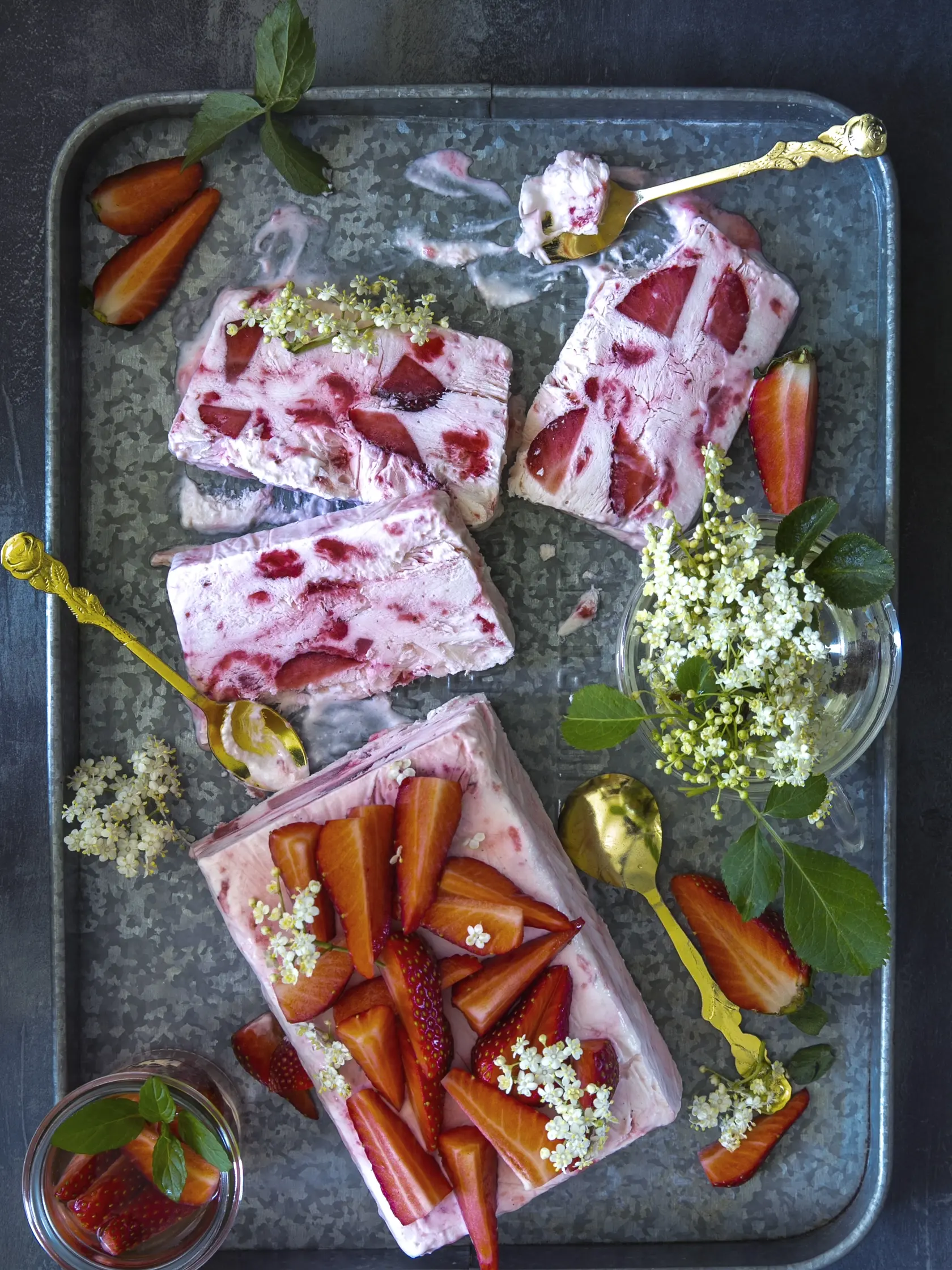 jahodovo bazové semifreddo

recept:
10 PORCIÍ PRÍPRAVA 25 MINÚT + MRAZENIE
• 500 g jahôd
• 50 g krupicového cukru
• 6 lyžíc bazového sirupu
• 300 g šľahačkovej smotany
• 300 g hustého gréckeho jogurtu
1. Litrovú formu na chlieb vysteľte potravi- nárskou fóliou. Do hrnca vsypte 300 g očis- tených jahôd nakrájaných na menšie kúsky. Pridajte cukor, 4 lyžice bazového sirupu. Varte, kým jahody nepustia šťavu a tá sa na polovicu zredukuje. Nechajte vychladnúť.
2. Smotan