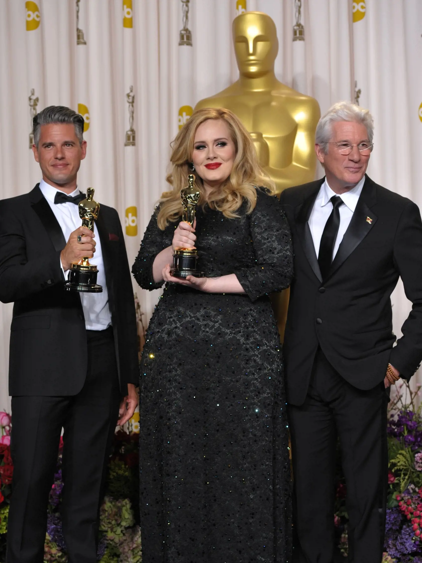 Adele and Paul Epworth pose with their award for best original song for "Skyfall" with presenter Richard Gere during the Oscars at the Dolby Theatre on Sunday Feb. 24, 2013, in Los Angeles. (Photo by John Shearer/Invision/AP)