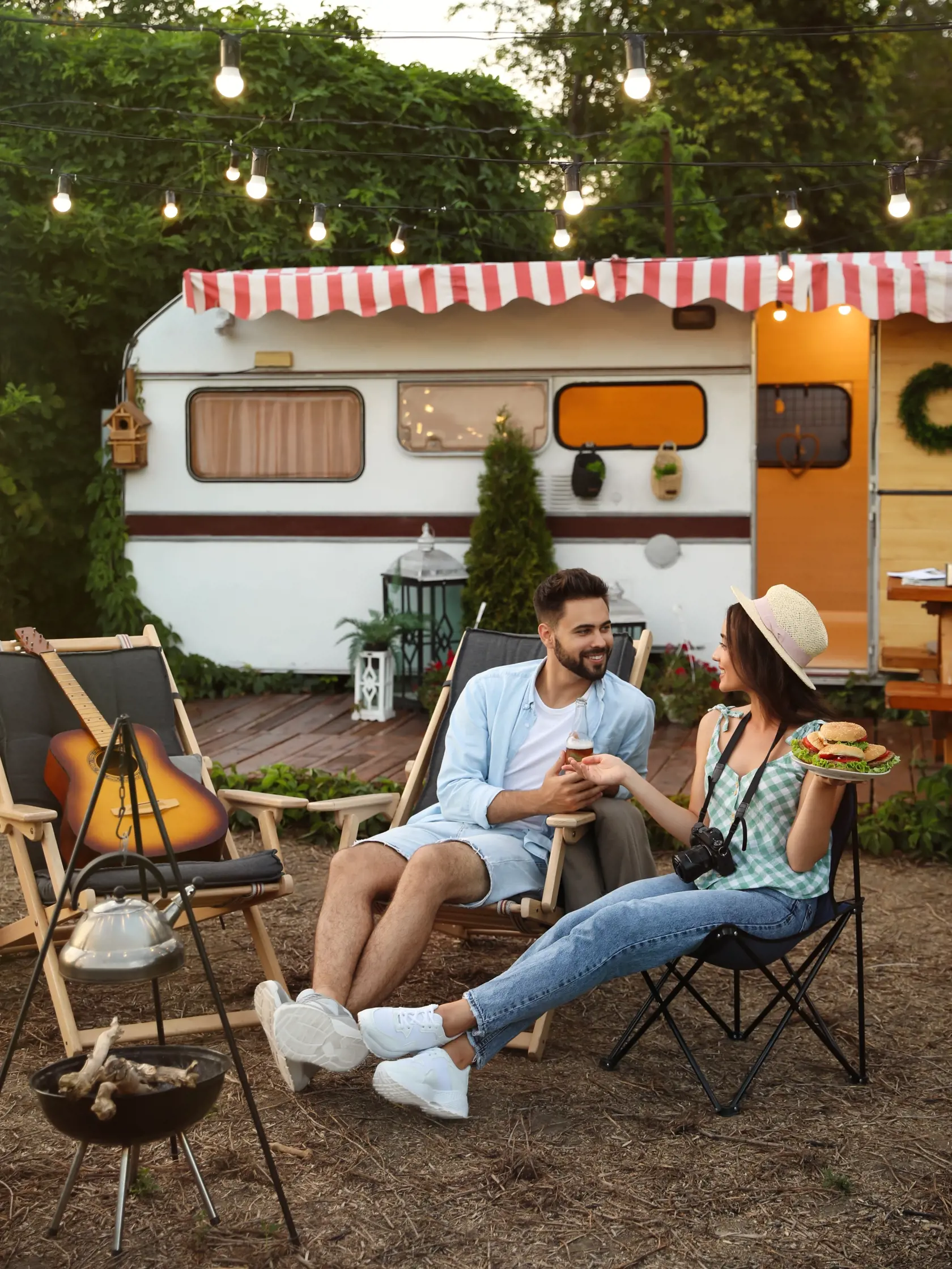 Happy,Couple,With,Burgers,And,Beer,Resting,Near,Trailer.,Camping