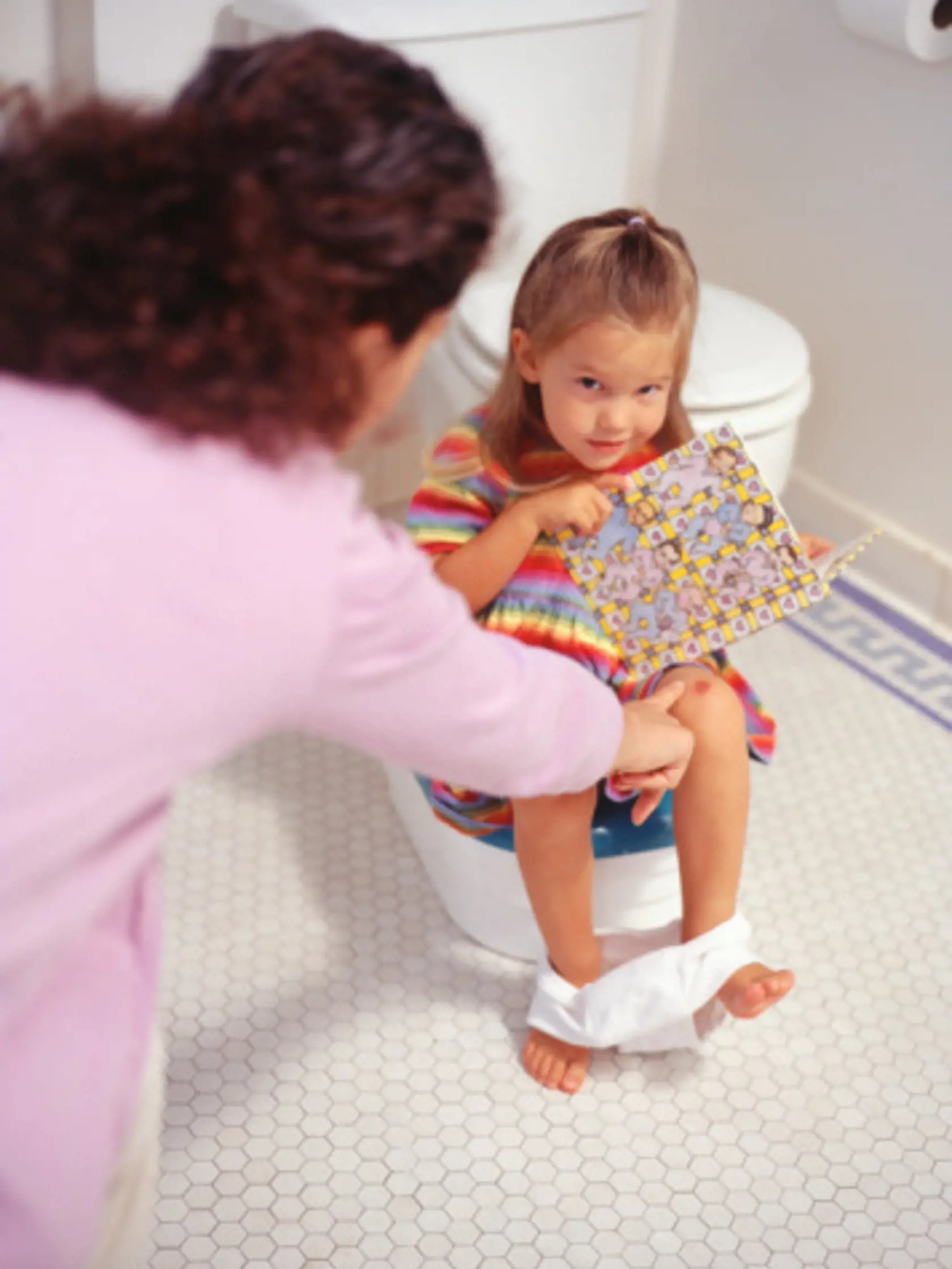 Mother potty training daughter (2-3), elevated view