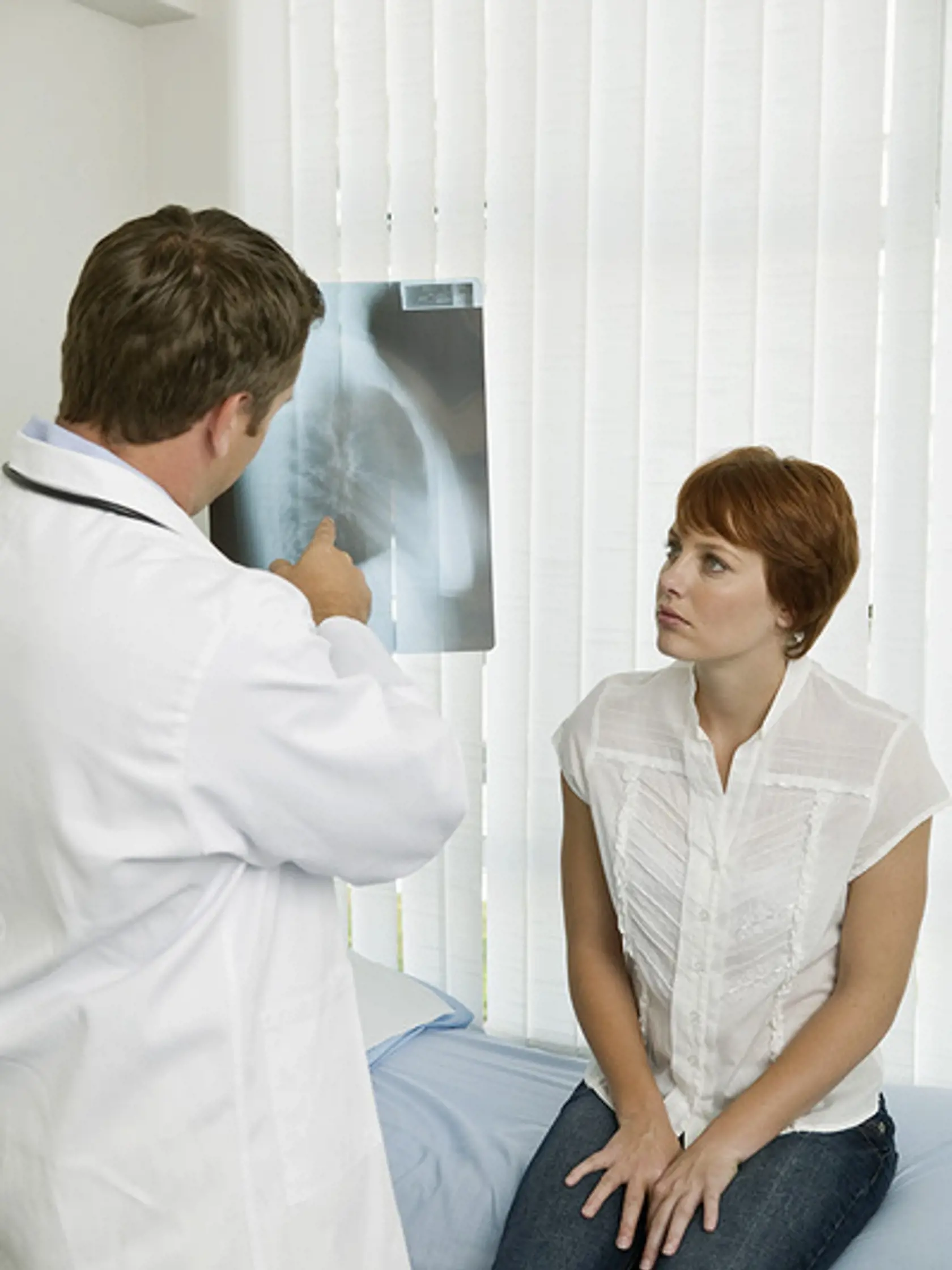 Doctor and patient examining x-ray