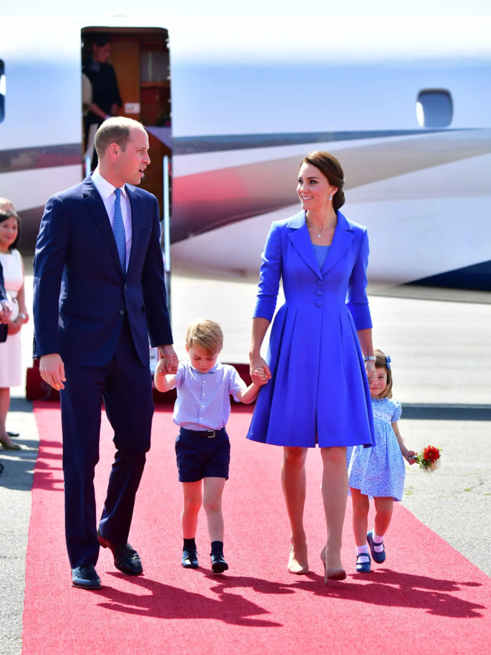 BERLIN, GERMANY - JULY 19:  Prince William, Duke of Cambridge, Catherine, Duchess of Cambridge with Prince George of Cambridge and Princess Charlotte of Cambridge as they arrive at Berlin Tegel Airport during an official visit to Poland and Germany on July 19, 2017 in Berlin, Germany.  (Photo by Robin Utrecht - Pool/Getty Images)