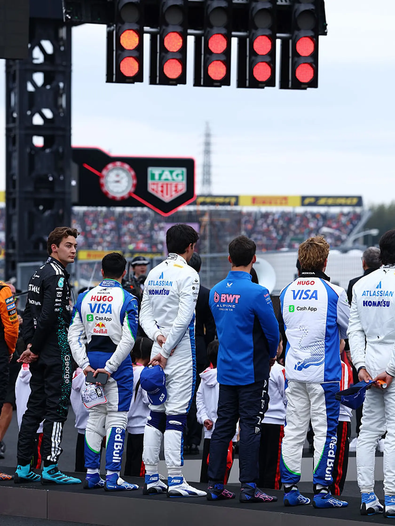 SUZUKA, JAPAN - APRIL 06: The drivers stand on the grid for the national anthem during the F1 Grand Prix of Japan at Suzuka Circuit on April 06, 2025 in Suzuka, Japan. (Photo by Mark Thompson/Getty Images)