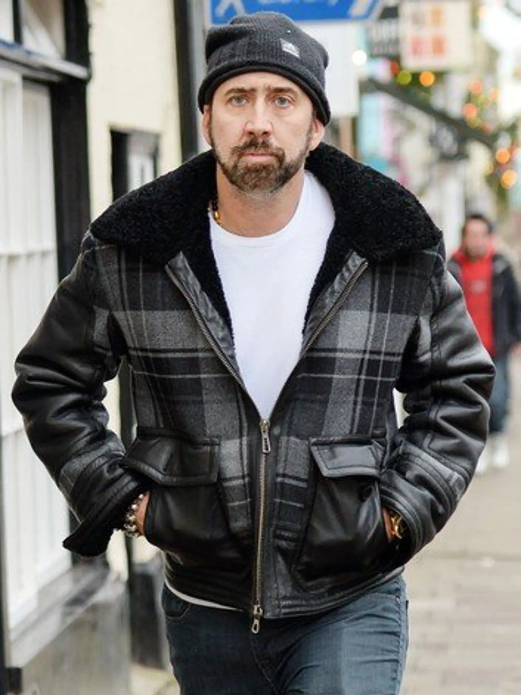 EXCLUSIVE-ALLROUND    Nicolas Cage in Glastonbury High Street  Nicolas Cage shopping in Glastonbury, Somerset, Britain - 16 Dec 2014  Oscar winning actor Nicolas Cage was spotted Christmas shopping in the Somerset town of Glastonbury with his son Kal-El and a family friend today.  Wearing a black Adidas beanie hat and a gray and black plaid leather bomber jacket, the 'Leaving Las Vegas' star browsed some of the quirky independent shops, which sell everything from healing crystals to cakes, unrec