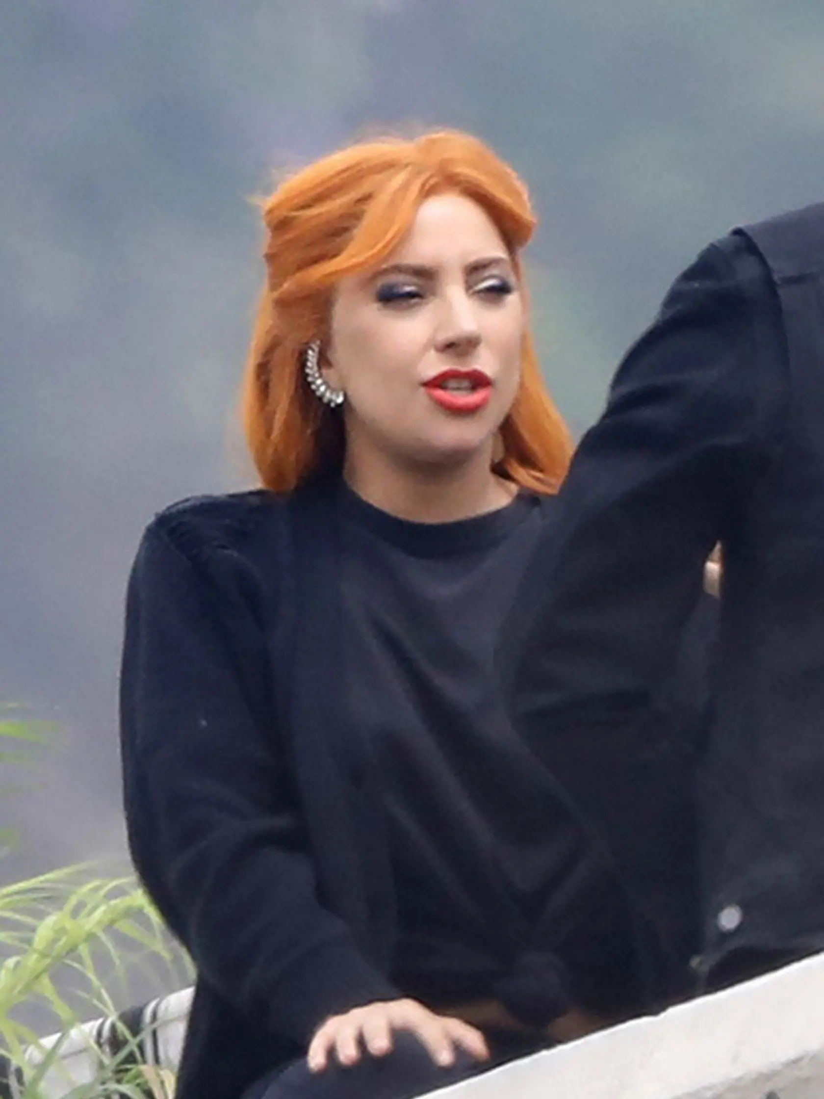 *EXCLUSIVE* Los Angeles, CA  - Lady Gaga and Bradley Cooper get into character while filming "A Star is Born." Gaga and Bradley are seen having an emotional discussion on a picturesque balcony after Bradley is seen consulting a crew member on getting the right shot for the scene. Bradley can also be seen wearing a ring on THAT finger, but whether he is wearing it for his character, or if it is a real engagement ring is unknown.    Pictured: Lady Gaga    BACKGRID USA 5 JUNE 2017, Image: 335182297