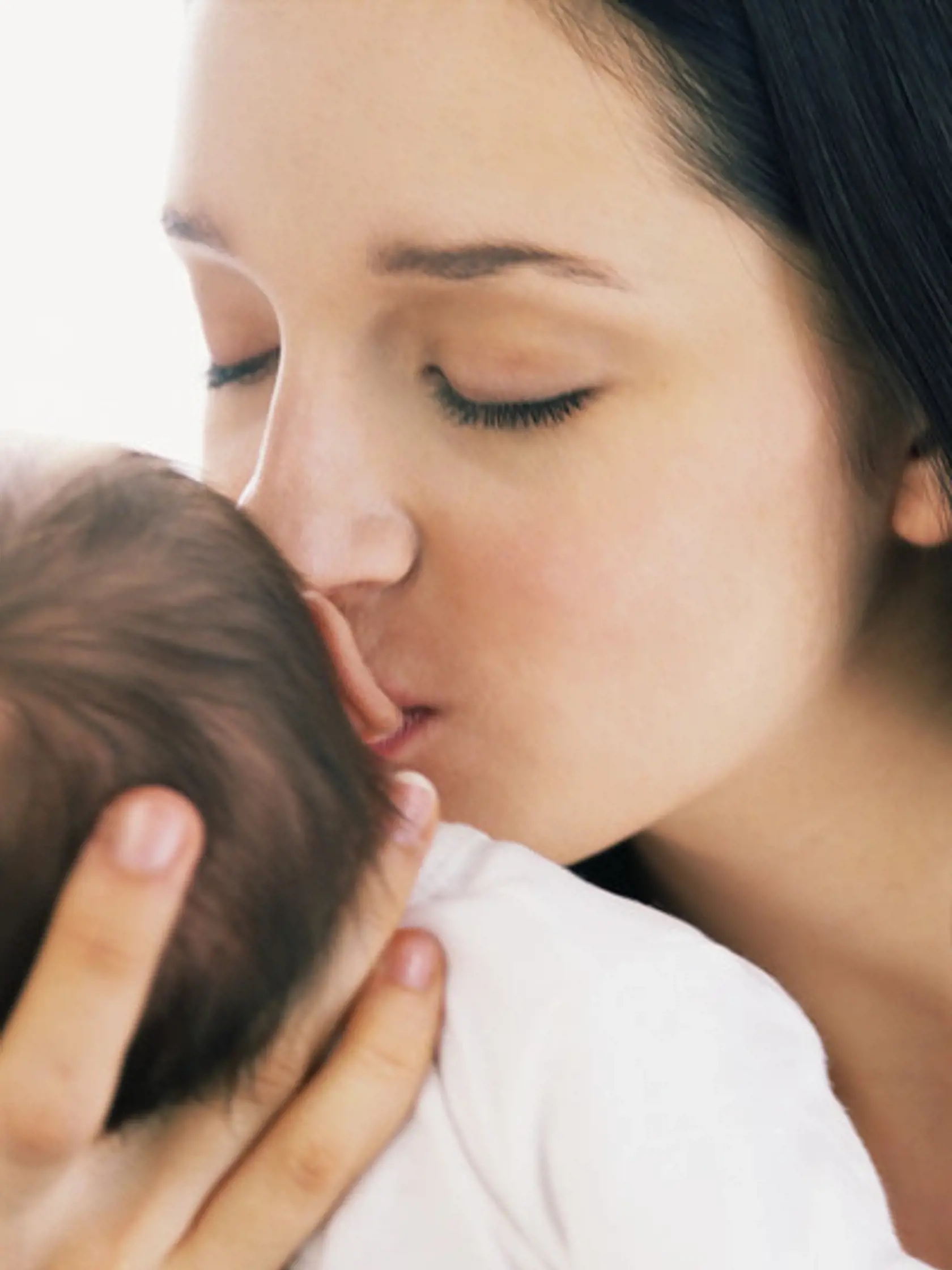 Young Mother Kissing Infant