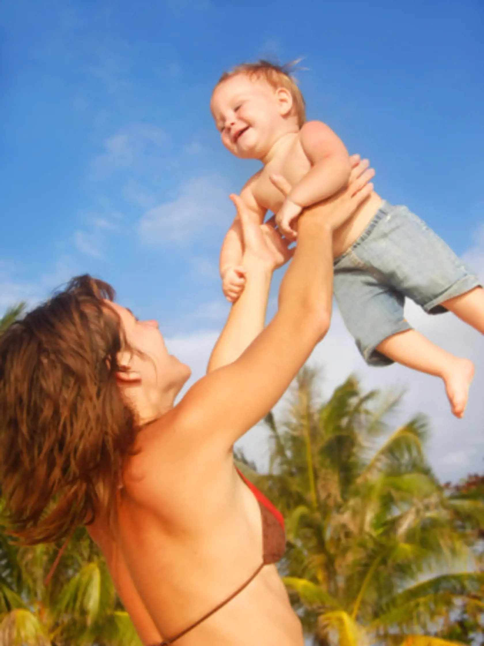 playing mother and child over sky background