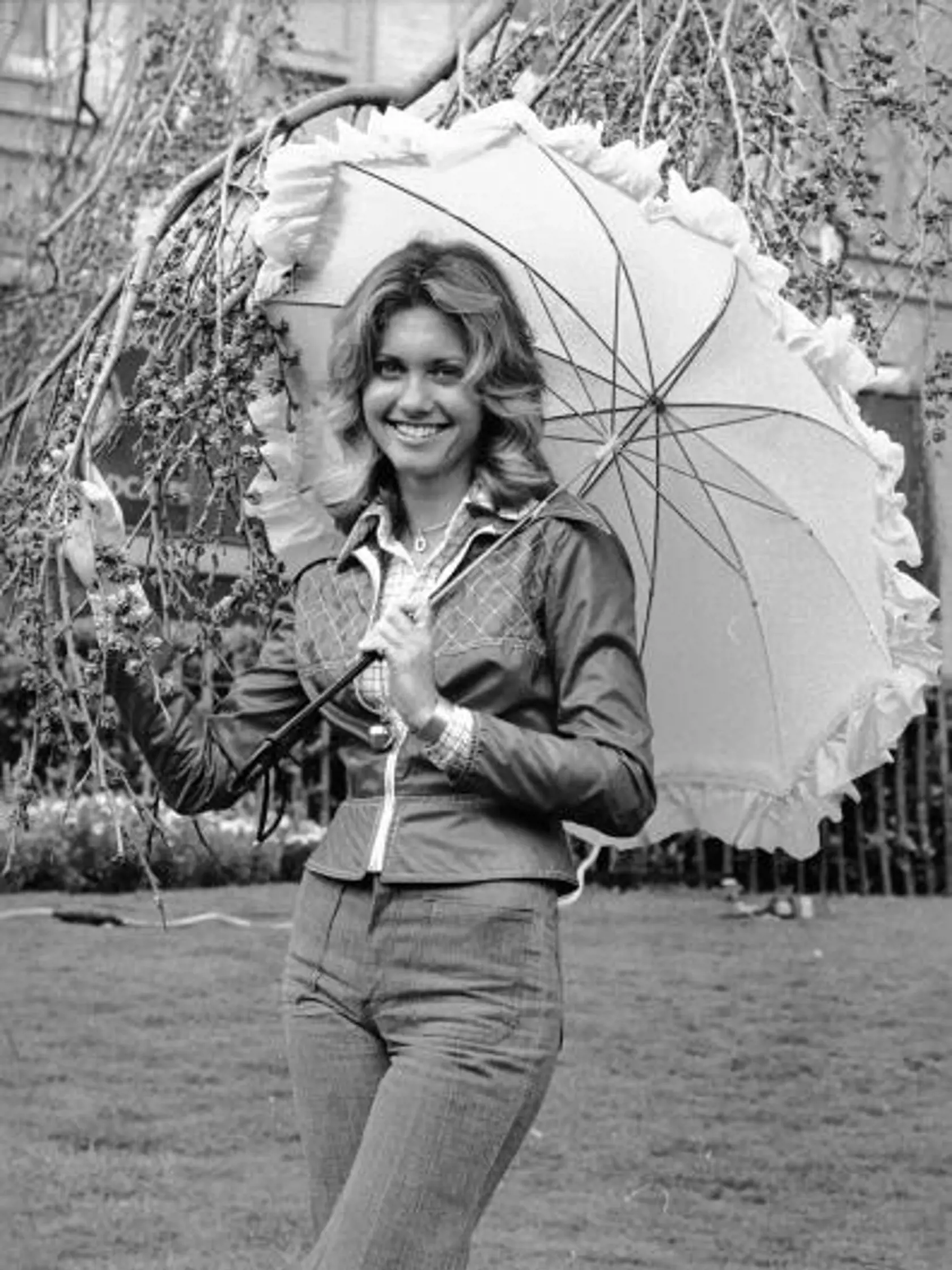 3rd April 1974:  British born Australian singer and actress, Olivia Newton-John, holding a parasol.  (Photo by Steve Wood/Express/Getty Images)