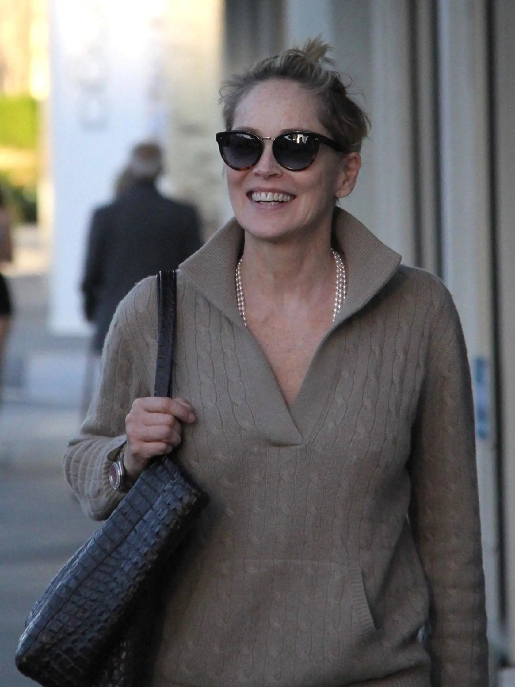 Beverly Hills, CA - Actress, Sharon Stone, appeared to be a woman half her age as she walked around Beverly Hills without a bit of make-up on.  She was seen wearing a wild hairdo that resembled that of 'Pebbles' from the Flintstones, a tan pullover sweater, blue jeans, suede boots.      February 8, 2016, Image: 273506616, License: Rights-managed, Restrictions: NO Brazil, Model Release: no, Credit line: Profimedia, AKM-GSI