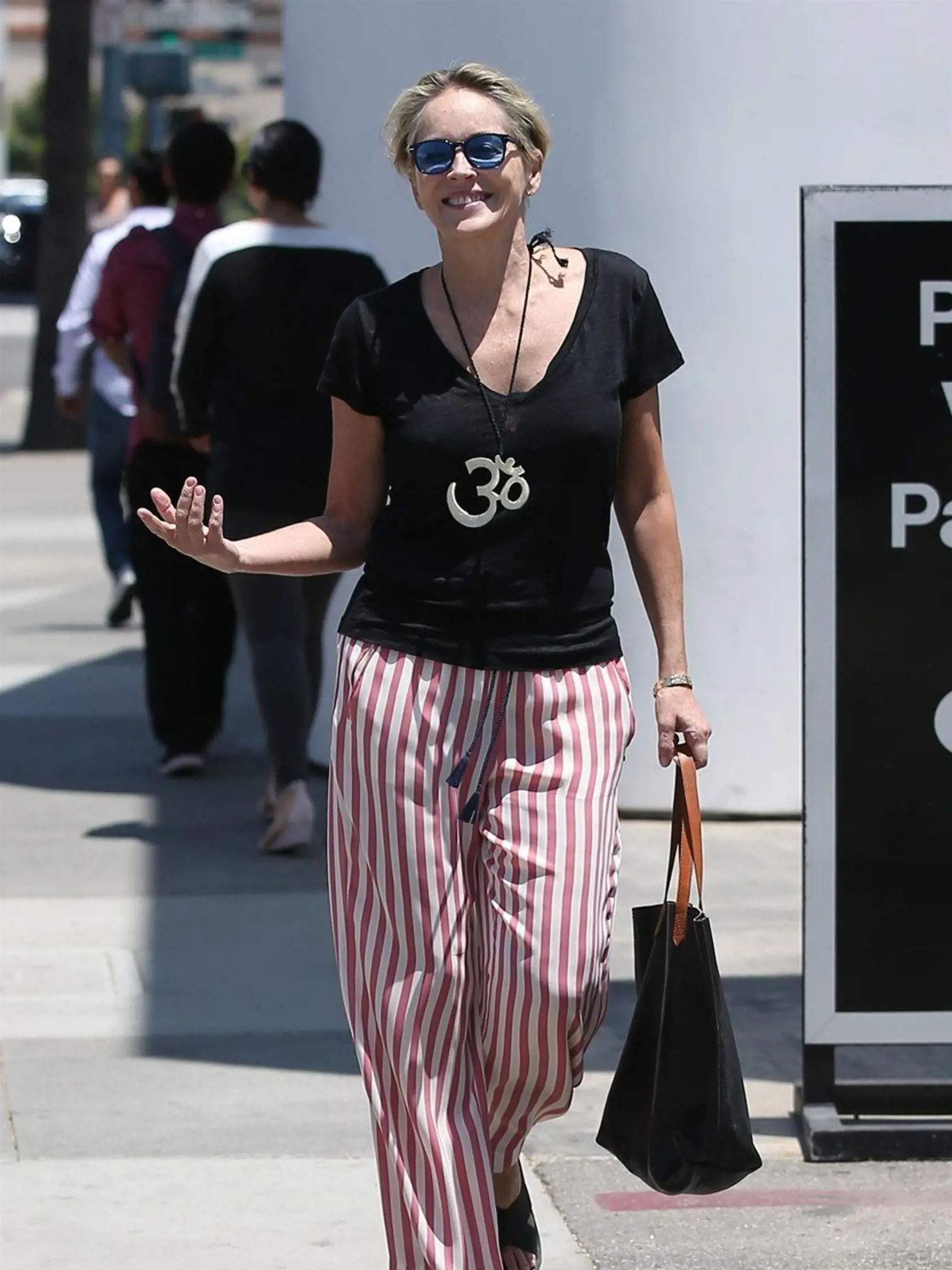 Beverly Hills, CA  - *EXCLUSIVE*  - Actress Sharon Stone is all about peace while shopping with a friend in Beverly Hills. Las week a letter written by Madonna in the 90's was auctioned off and in the letter she stated that Sharon and Whitney Houston were 'horribly mediocre'. Sharon quickly came out and responded with 'Know that i am your friend, I have wished to be a rock star in some moments.... have felt as mediocre as you described. We know, as only those who have survived so long that ownin