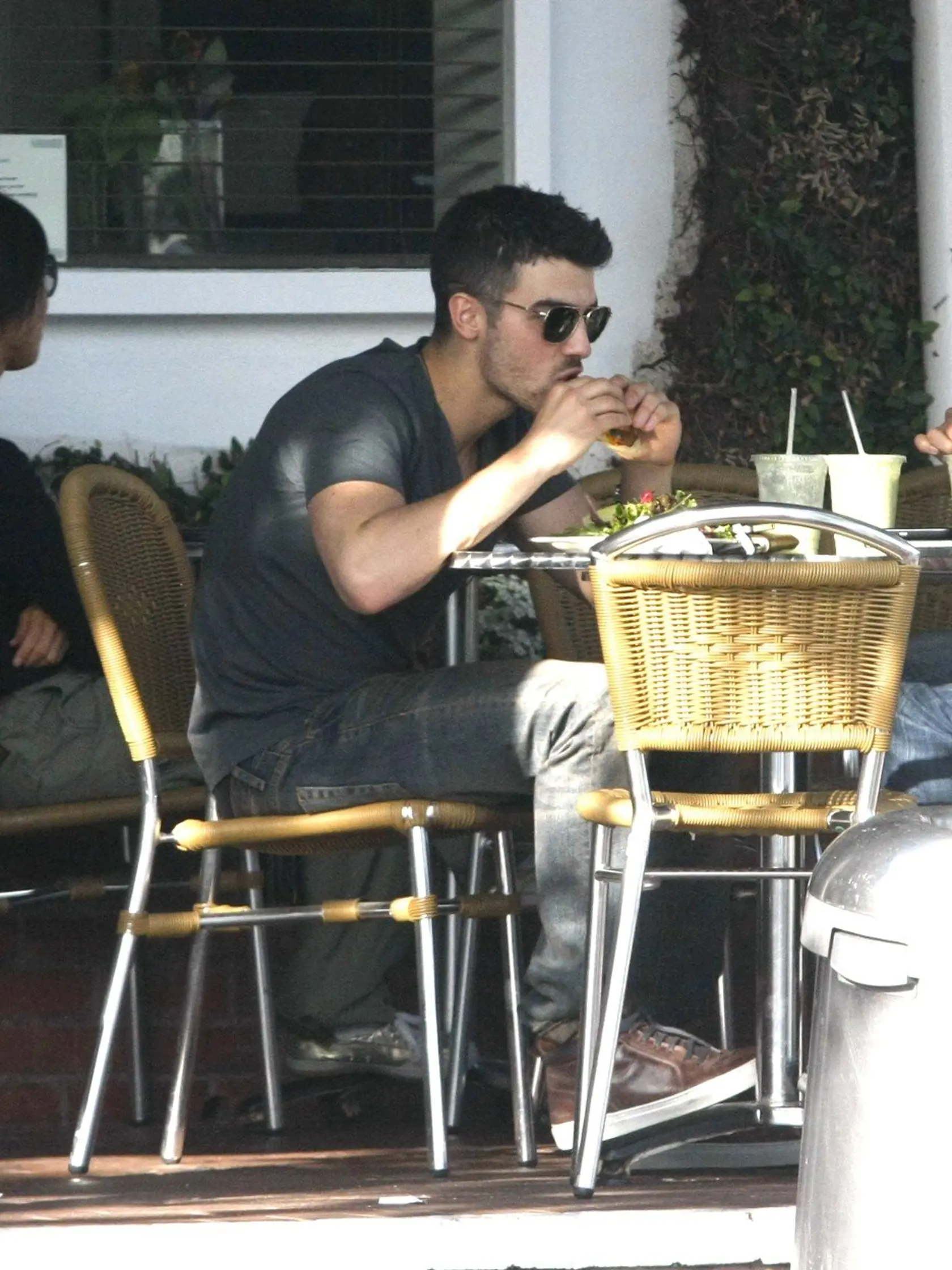 BEVERLY HILLS - MARCH 04: Joe Jonas wore a pair of dark sunglasses, gray t-shirt, gray jeans and brown shoes while eating a cheese burger at Fred Segal on March 4, 2011 in Beverly Hills., Image: 91312801, License: Rights-managed, Restrictions: *US MAGAZINES-PLEASE REPORT USAGE*  **FEE MUST BE AGREED PRIOR TO USAGE **  ***E-TABLET/IPAD & MOBILE PHONE APP PUBLISHING REQUIRES ADDITIONAL FEES***, Model Release: no, Credit line: Profimedia, Buzzfoto