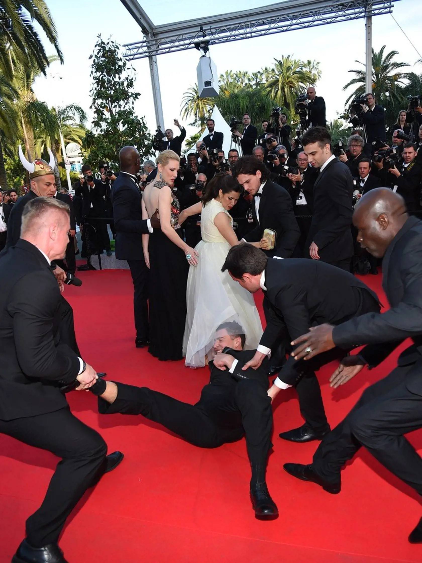 May 16, 2014: A Ukrainian journalist, 25-year-old Vitalii Sediuk, dives under America FerreraÃ¢â‚¬â„¢s dress as she poses with her Ã¢â‚¬ï¿½How to Train Your Dragon 2' costars Jay Baruchel, Kit Harington, Cate Blanchett and Djimon Hounsou during the 67th Annual Cannes Film Festival in Cannes, France.  He was immediately taken away by security., Image: 193859190, License: Rights-managed, Restrictions: US, UK, AUSTRALIA, BELGIUM, HUNGARY, NETHERLANDS, SCANDINAVIA SALES ONLY., Model Release: no, Cre