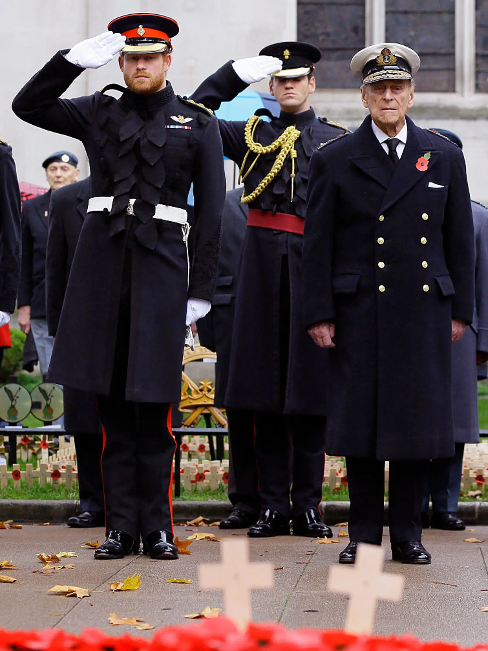 LONDON, ENGLAND - NOVEMBER 05:  Prince Harry salutes next to Prince Philip, Duke of Edinburgh during a Service in the Field of Remembrance at Westminster Abbey on November 5, 2015 in London, England.  (Photo by Kirsty Wigglesworth - WPA Pool/Getty Images)