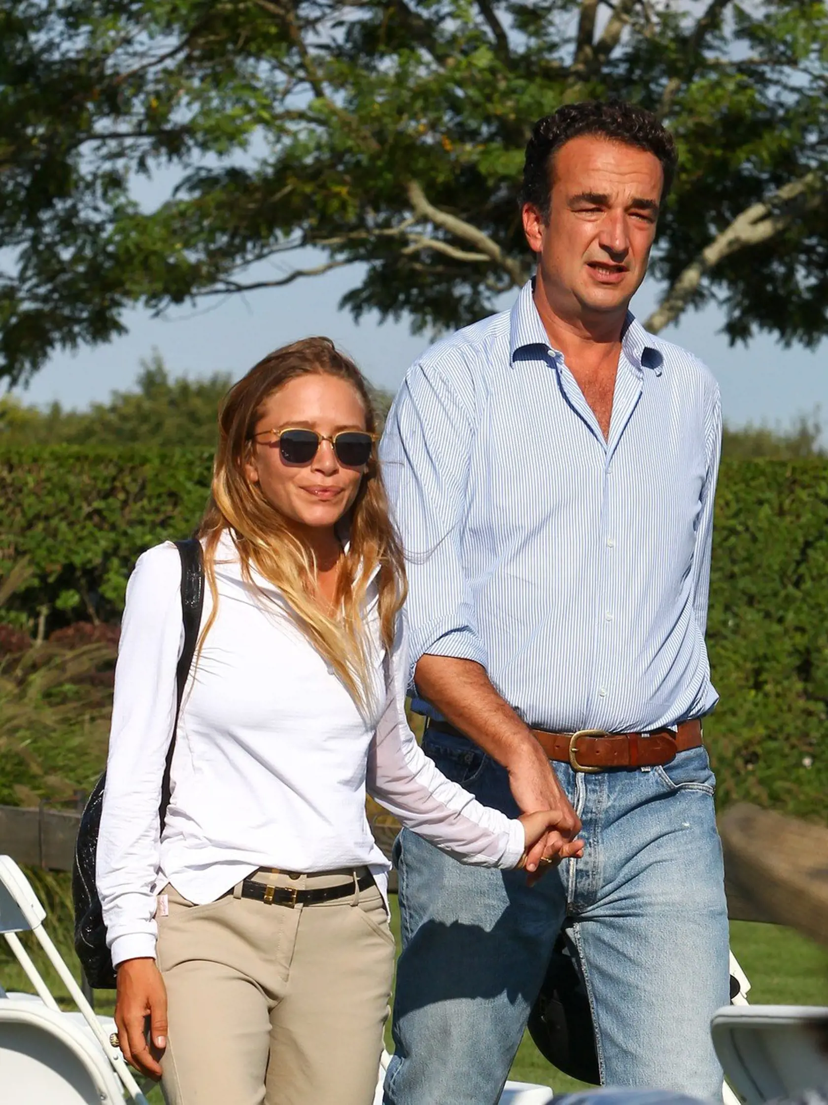 EXCLUSIVE TO INF. August 27, 2015: Mary-Kate Olsen, dressed in riding gear, and husband Olivier Sarkozy, are seen holding hands while attending the 2015 Hampton Classic Horse Show in the Hamptons, New York. Mary-Kate and twin sister Ashley are currently involved in a lawsuit filed against their company, Dualstar. The suit was brought by a group of former interns who are claiming the company has failed to pay about 40 past and present employees, who had to work long hours performing menial tasks.