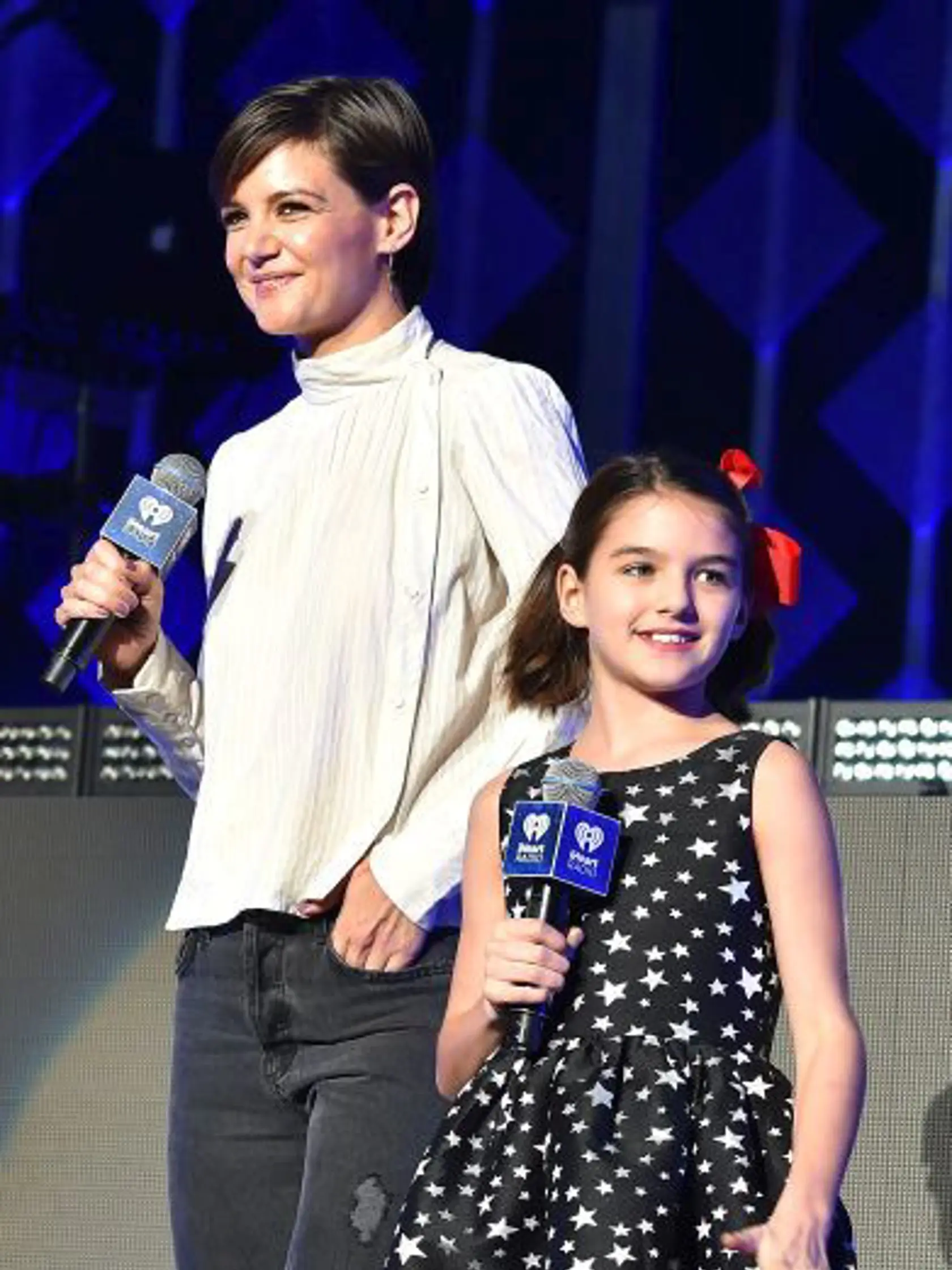 NEW YORK, NY - DECEMBER 08:  Elvis Duran, Katie Holmes and Suri Cruise speak at Z100's Jingle Ball 2017 on December 8, 2017 in New York City.  (Photo by Theo Wargo/Getty Images for iHeartMedia)