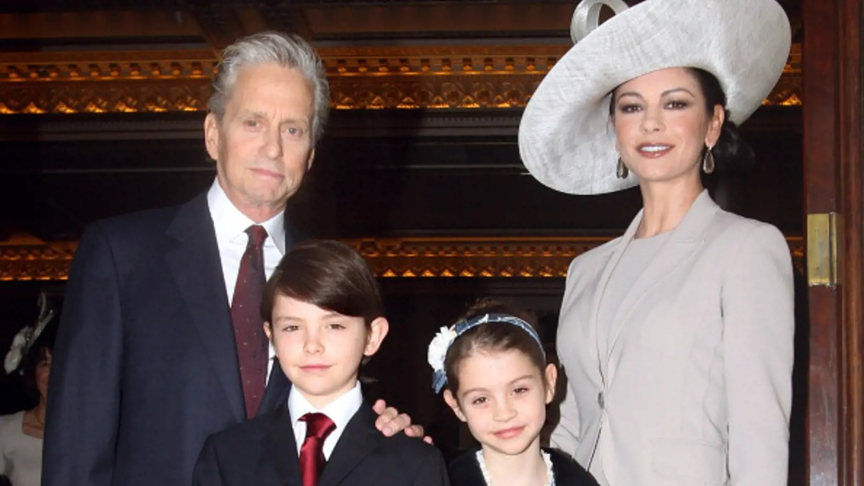 LONDON - FEBRUARY 24:  Actress Catherine Zeta-Jones (R) arrives with her husband, actor Michael Douglas and their children Dylan and Carys Douglas, to attend a Royal Investiture at Buckingham Palace on February 24, 2011 in London, England. The 41-year-old Swansea-born actress Catherine Zeta-Jones, who became an Oscar-winning Hollywood star was presented with a CBE by Prince Charles, Prince of Wale in honour of services to the film industry and to charity.  (Photo by Lewis Whyld - WPA Pool/Getty 