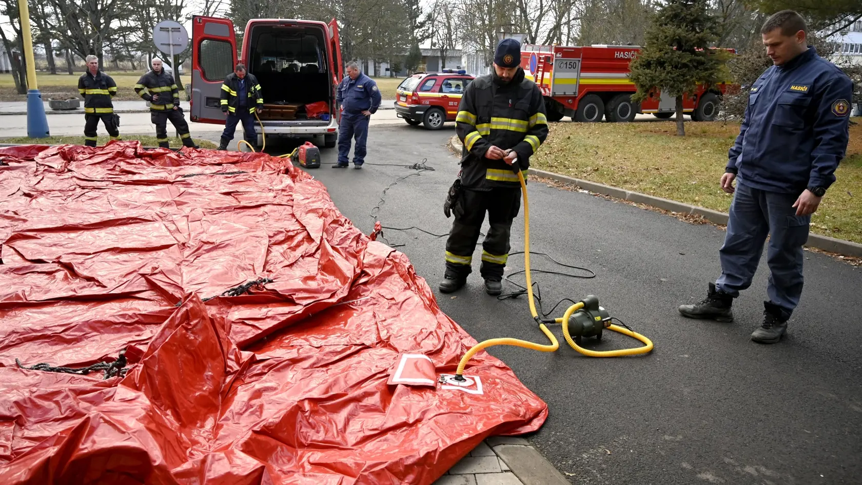 Triážne stany pred nemocnicami, ktoré počas štvrtej vlny pandémie poslúžia ako triediace pracoviská pre pacientov pred urgentnými príjmami, postavia príslušníci Hasičského a záchranného zboru (HaZZ). Na snímke hasiči stavajú triediaci stan pred urgentným príjmom Nemocnice Svet zdravia a.s. v Trebišove 3. februára 2022. FOTO TASR - Roman Hanc