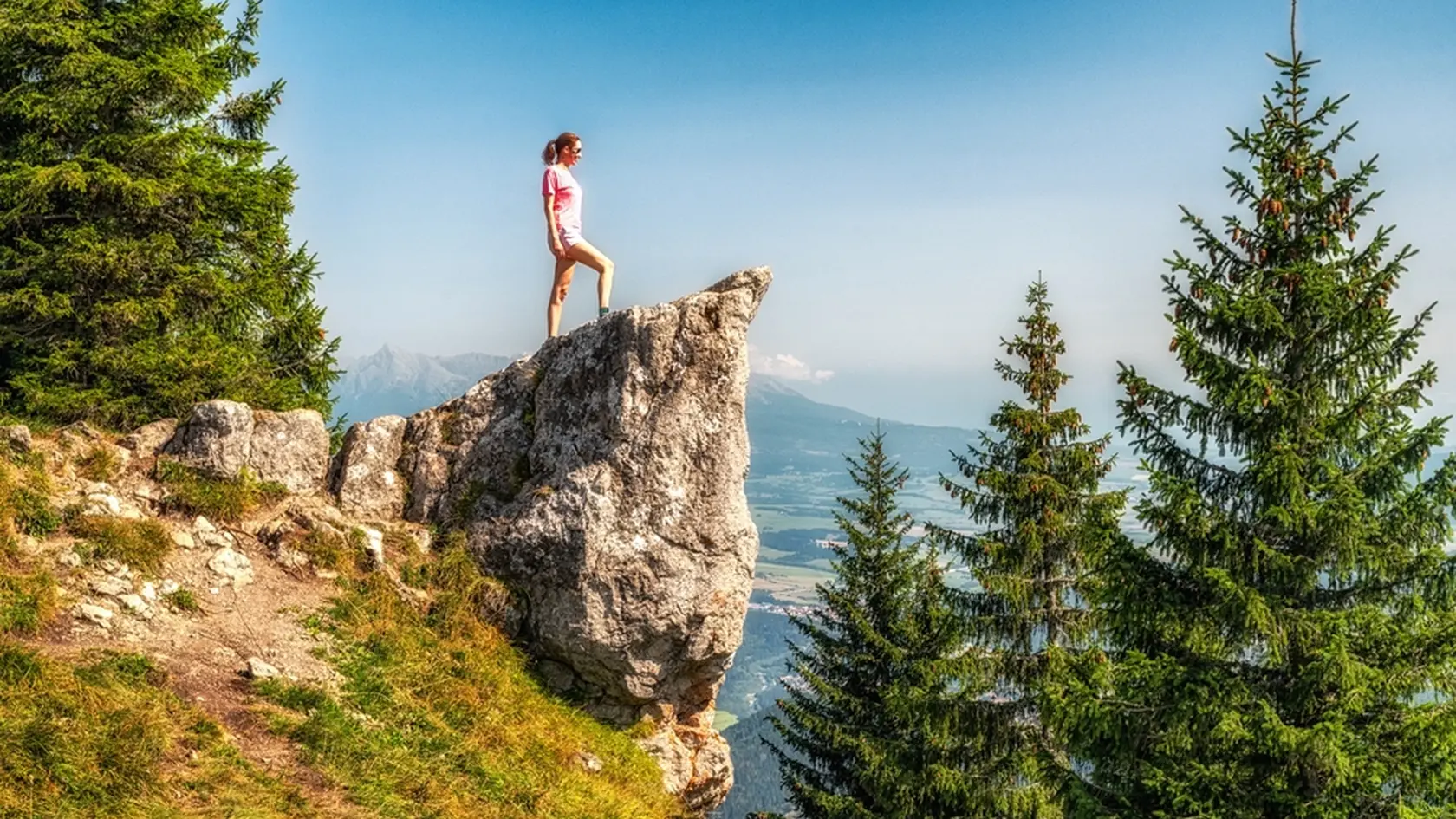 Girl hiker posing on top of the hill Poludnica in Low Tatras mountains in Slovakia. High Tatras mountains with peak Krivan at background