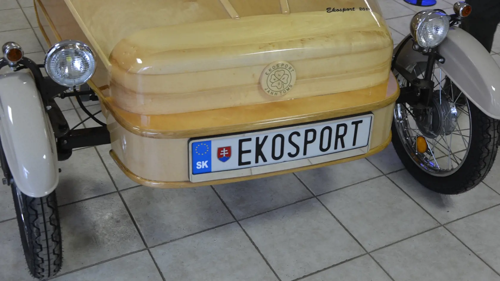 Na prednej časti je v drevenom krúžku emblém i značka auta Ekosport. 