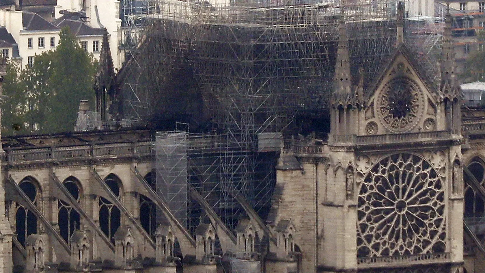 Notre Dame cathedral is pictured from the top of the Montparnasse tower, Tuesday April 16, 2019 in Paris. Firefighters declared success Tuesday morning in an over 12-hour battle to extinguish an inferno engulfing Paris' iconic Notre Dame cathedral that claimed its spire and roof, but spared its bell towers. (AP Photo/Thibault Camus)