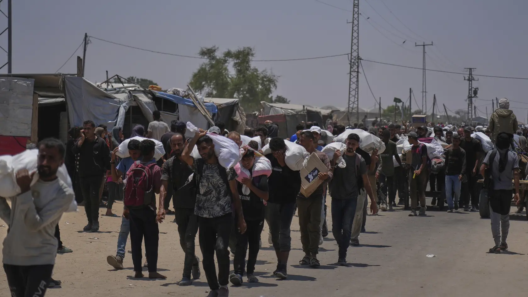 AZ10 Rafah - Palestínčania nesú tašky s potravinami a balíčkami humanitárnej pomoci v meste Rafah 9. júna 2025. Izraelské sily prevzali kontrolu nad humanitárnou loďou, ktorá sa pokúsila prelomiť námornú blokádu Pásma Gazy. Plavidlo s 12 ľuďmi na palube, vrátane aktivistky Grety Thunbergovej, teraz smeruje do prístavu v Izraeli, oznámili v noci na pondelok izraelské úrady a organizátori plavby. FOTO TASR/AP 

Palestinians carry bags containing food and humanitarian aid packages delivered by the Gaza Humanitarian Foundation, a U.S.-backed organization, in Rafah, southern Gaza Strip, Monday, June 9, 2025. (AP Photo/Abdel Kareem Hana)