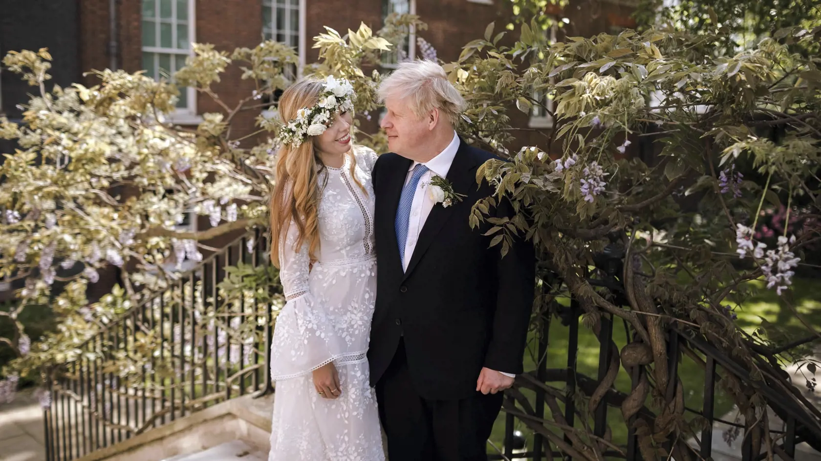 Na snímke, ktorú vydal úrad britské premiéra v nedeľu 30. mája 2021, britský premiér Boris Johnson a jeho snúbenica Carrie Symondsová pózujú po svadobnom obrade v záhrade na Downing Street 10 v Londýne.