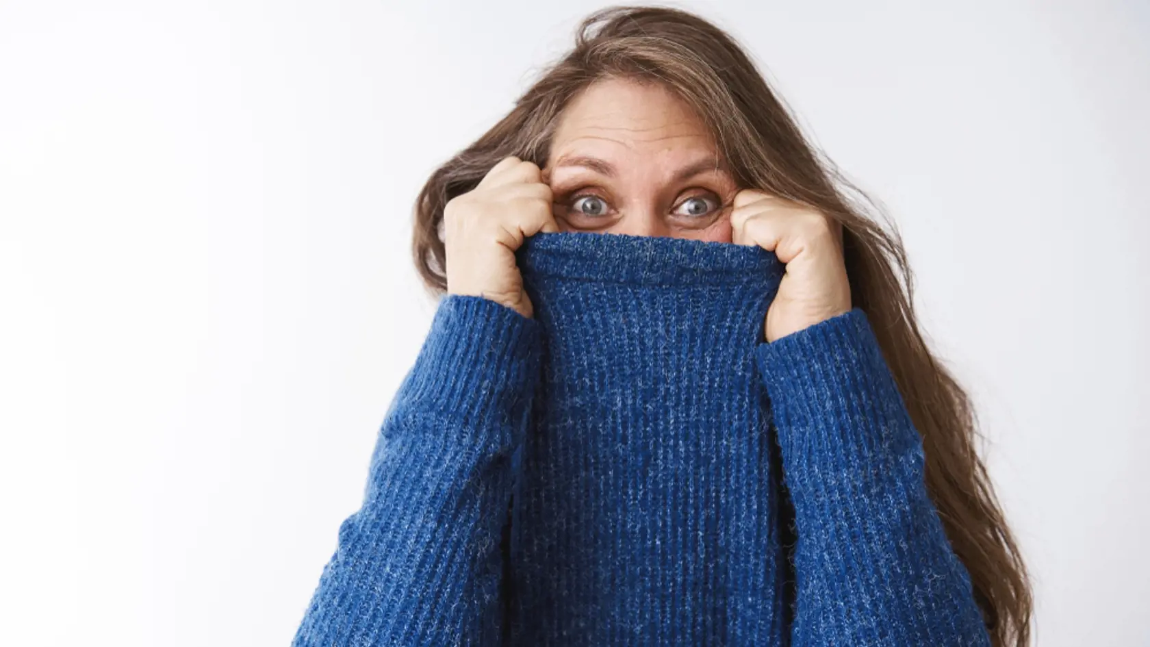 Woman,Hiding,In,Sweater,,Fooling,Around.,Joyful,And,Energized,Middle-aged