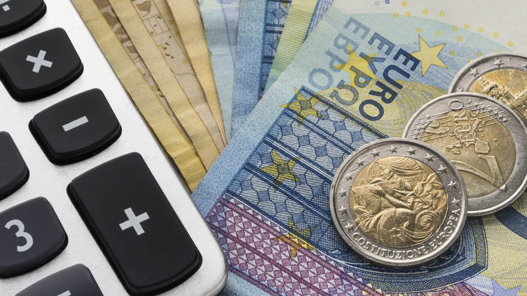 Close up of a calculator and euro money in a financial analyzing concept