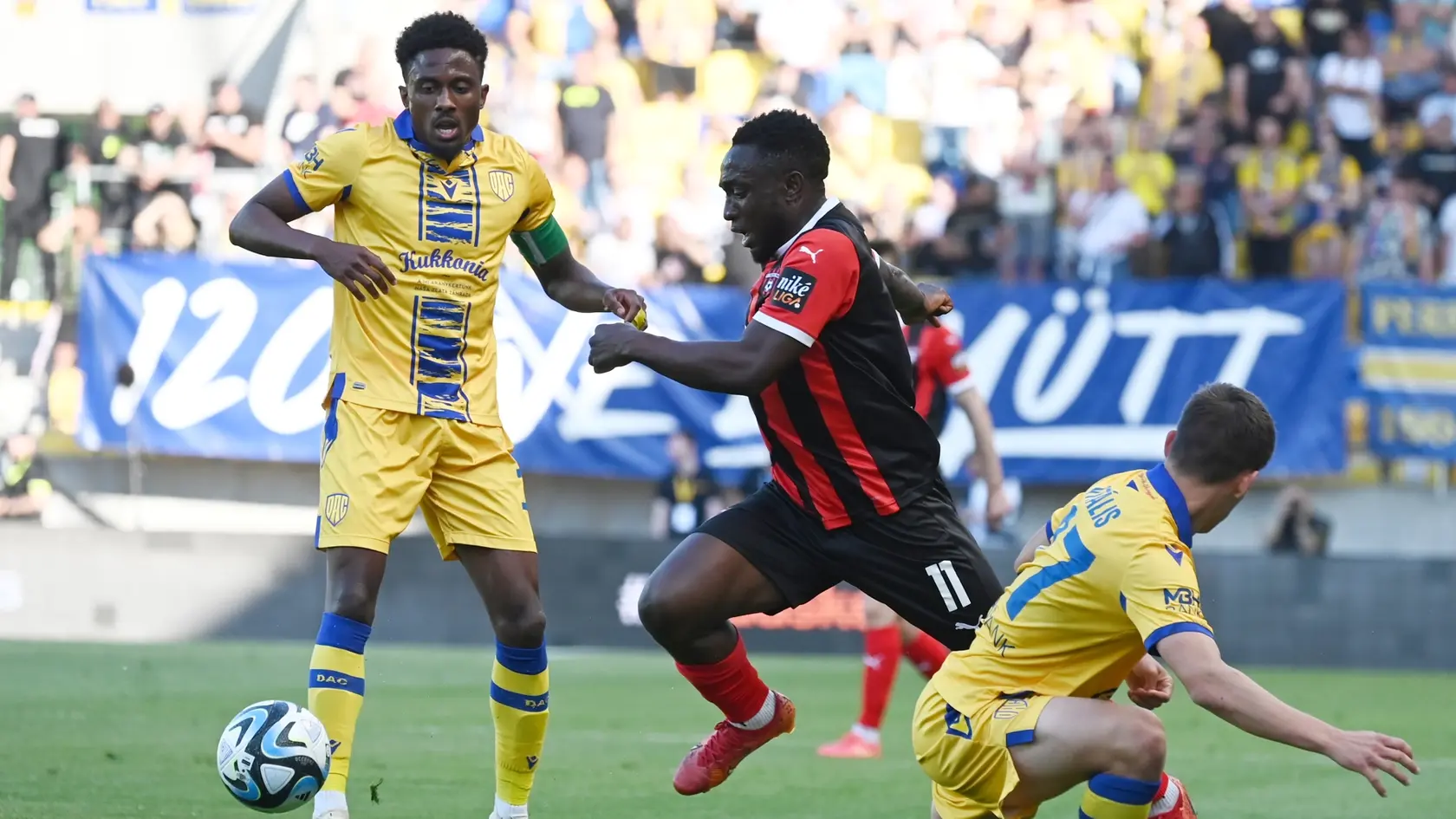 Na snímke zľava kapitán DAC Yhoan Andzouana, hráč Spartaka Philip Azango a hráč DAC Milán Vitális počas zápasu.