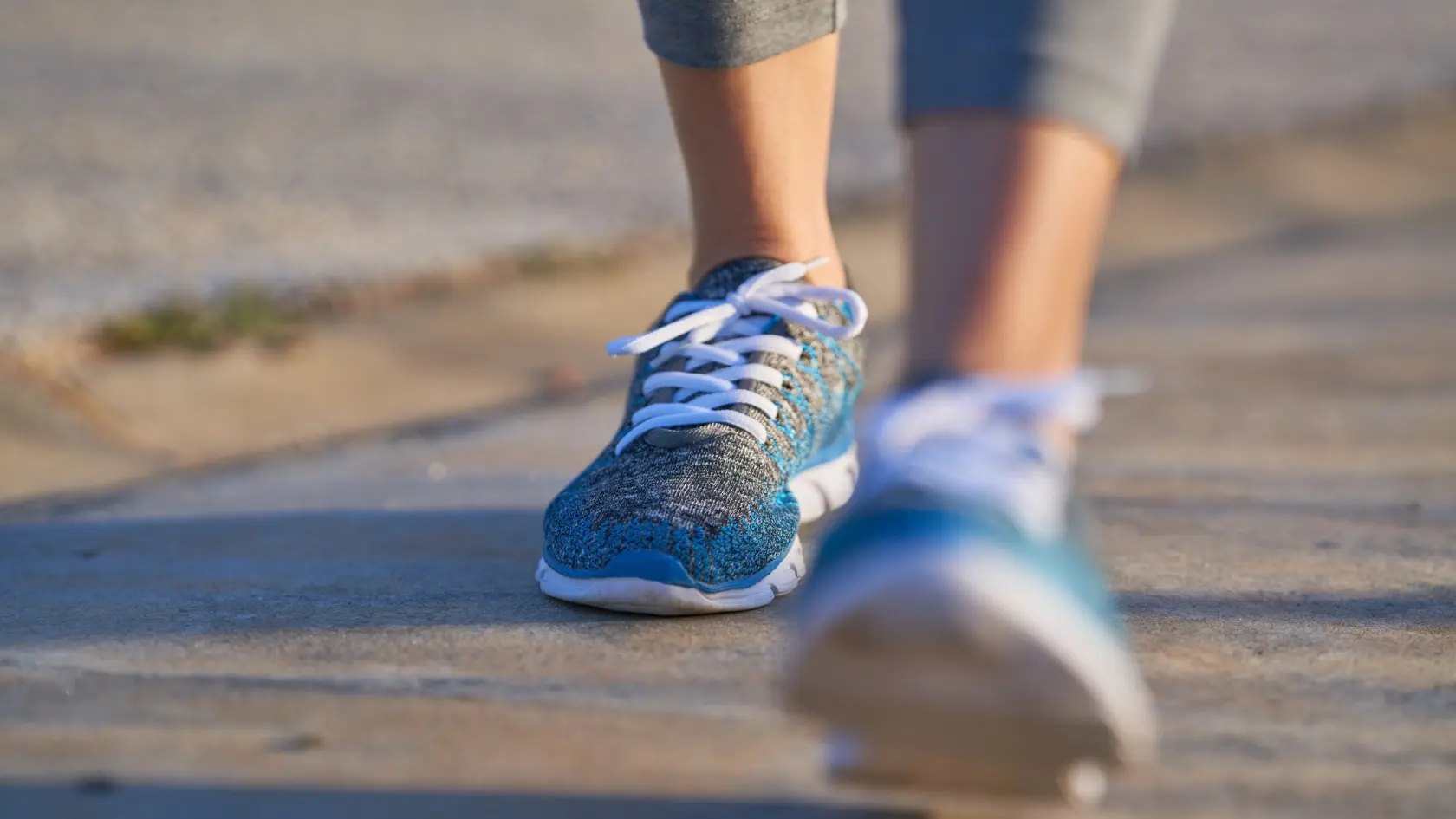 view of feet of sporty woman walking, copy space, unfocused view