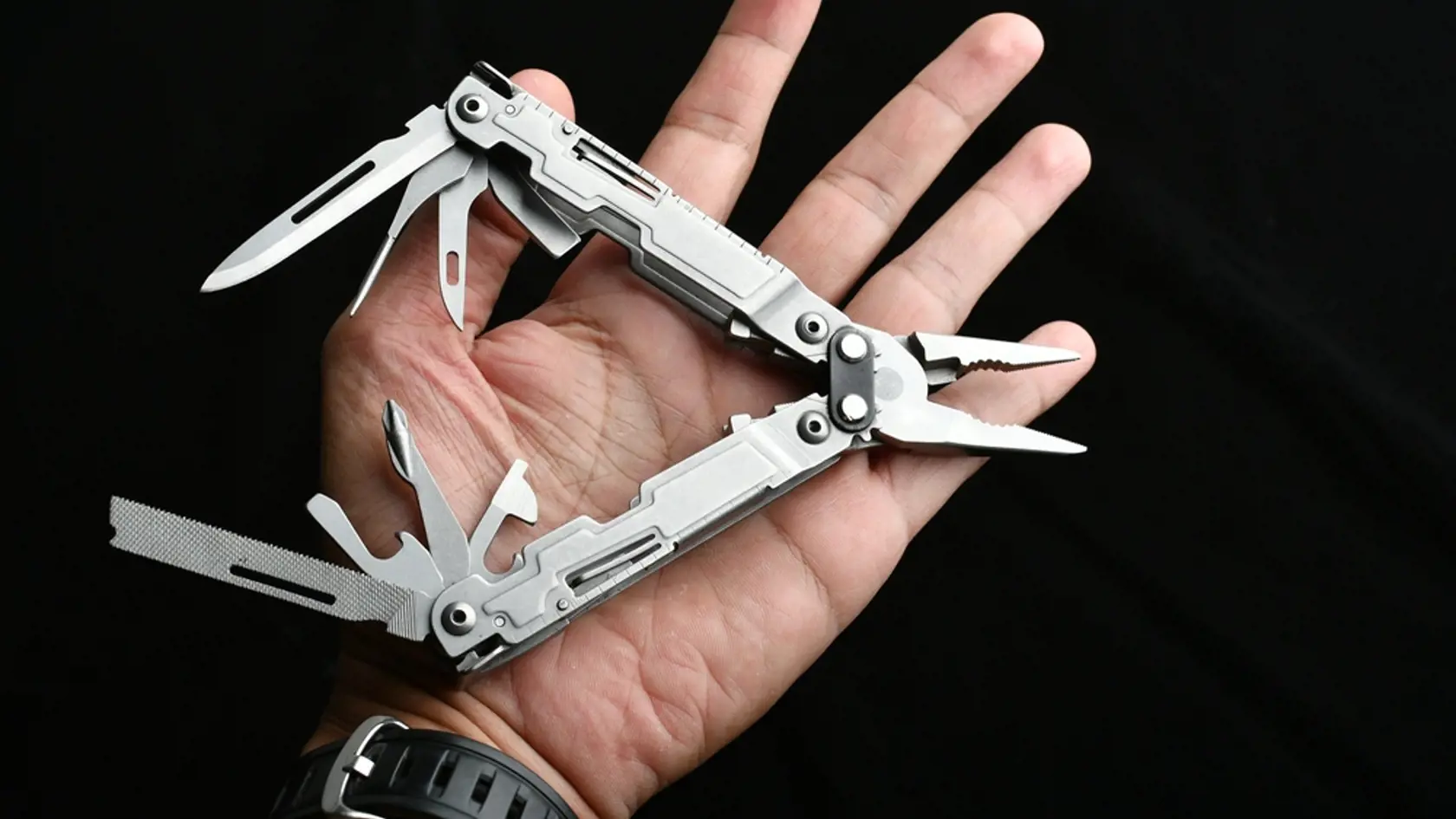 Man,Holding,Multitool,On,Black,Background,,Closeup