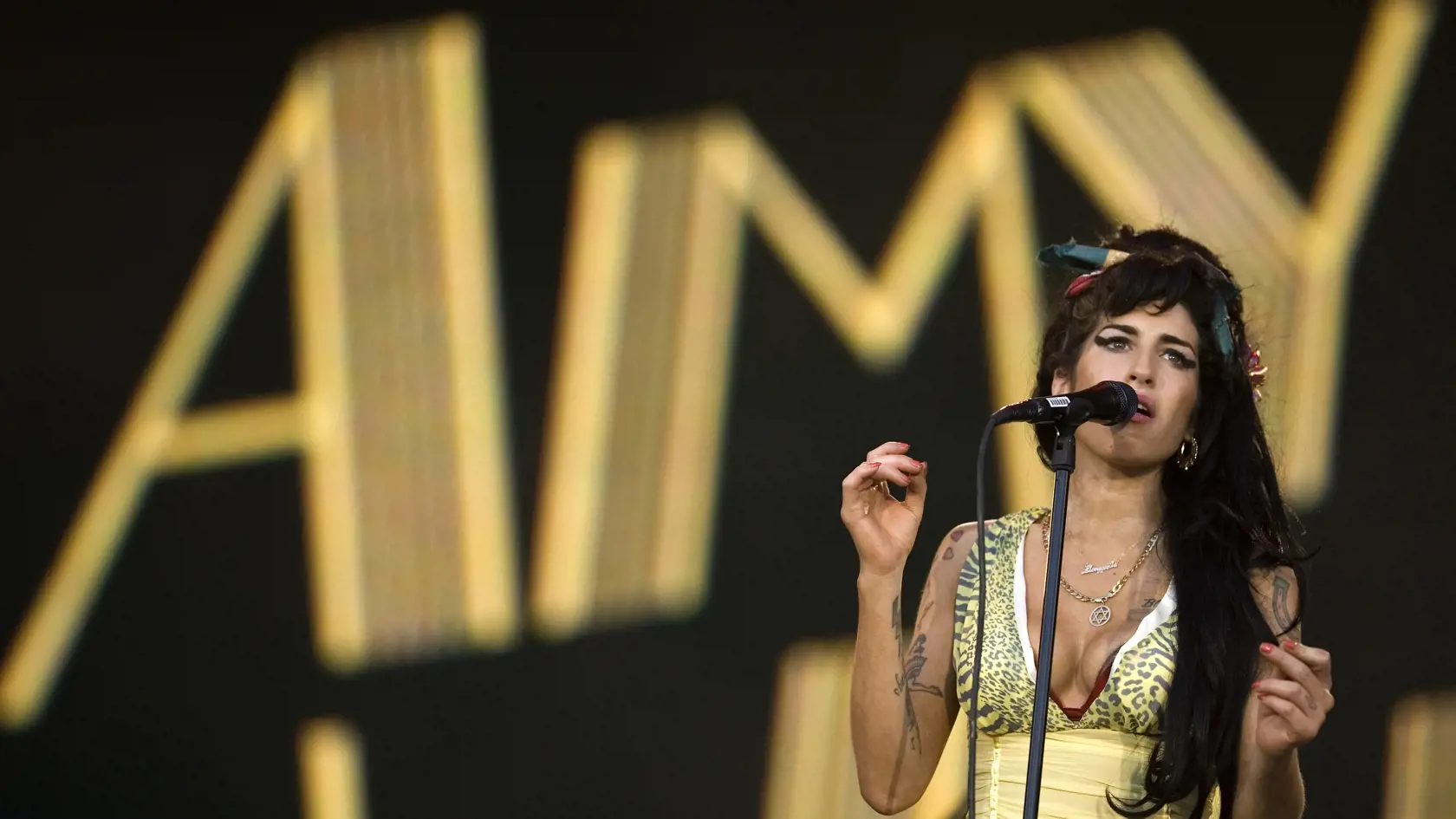 FILE - In this file photo dated Friday, July 4, 2008, Jazz Soul singer Amy Winehouse, from England, performs during the Rock in Rio music festival in Arganda del Rey, on the outskirts of Madrid. A new movie entitled "Amy" directed by Asif Kapadia, is scheduled for release on Friday July 3, 2015. Critics love the movie and top performers sing the praises of the late Amy Winehouse, but the singer's father, Mitch Winehouse, says the film has been edited to depict the family as doing too little to h