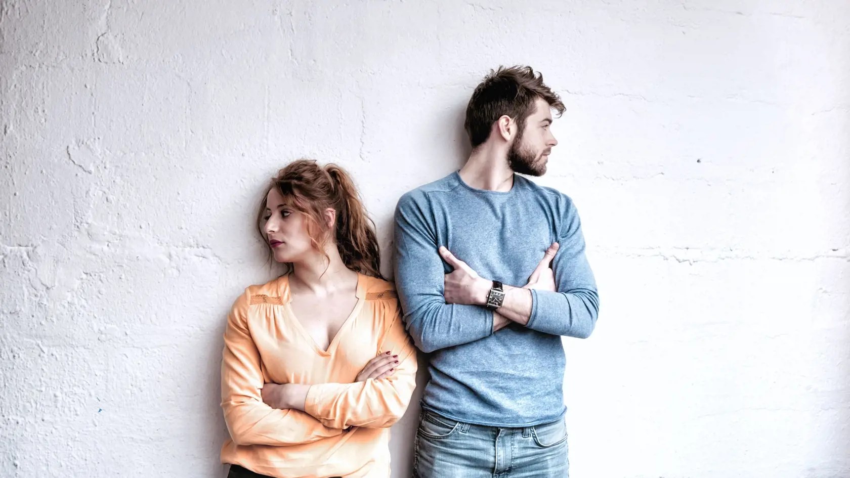 serious young french couple looking in opposite directions