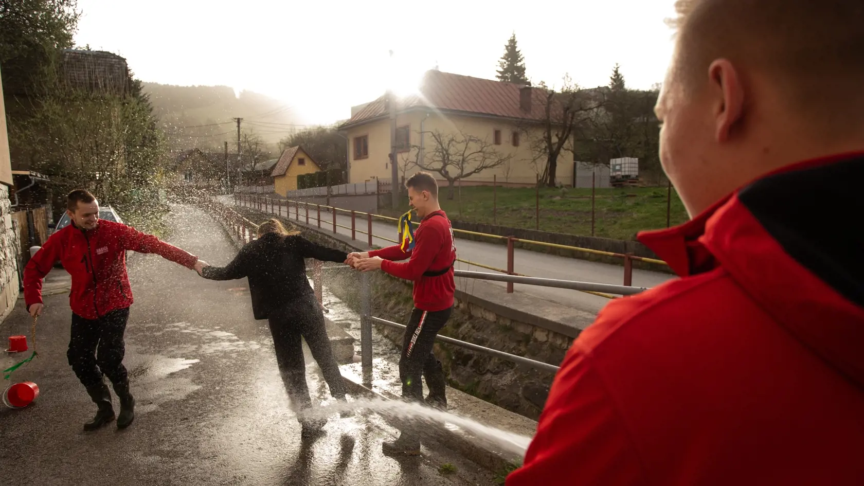 Na snímke dobrovoľní hasiči z Dobrovoľného hasičského zboru (DHZ) Oškerda oblievajú ženu počas veľkonočnej oblievačky a šibačky v obci Snežnica v okrese Kysucké Nové Mesto v pondelok 1. apríla 2024.