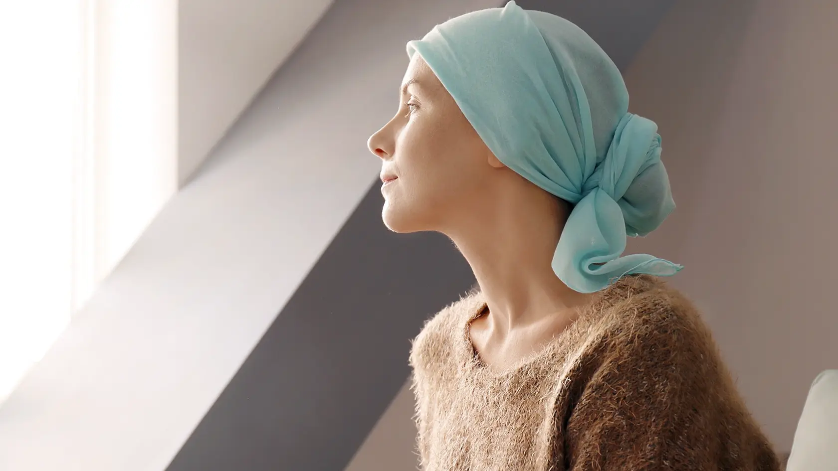 Young,Woman,With,Cancer,In,Headscarf,Indoors