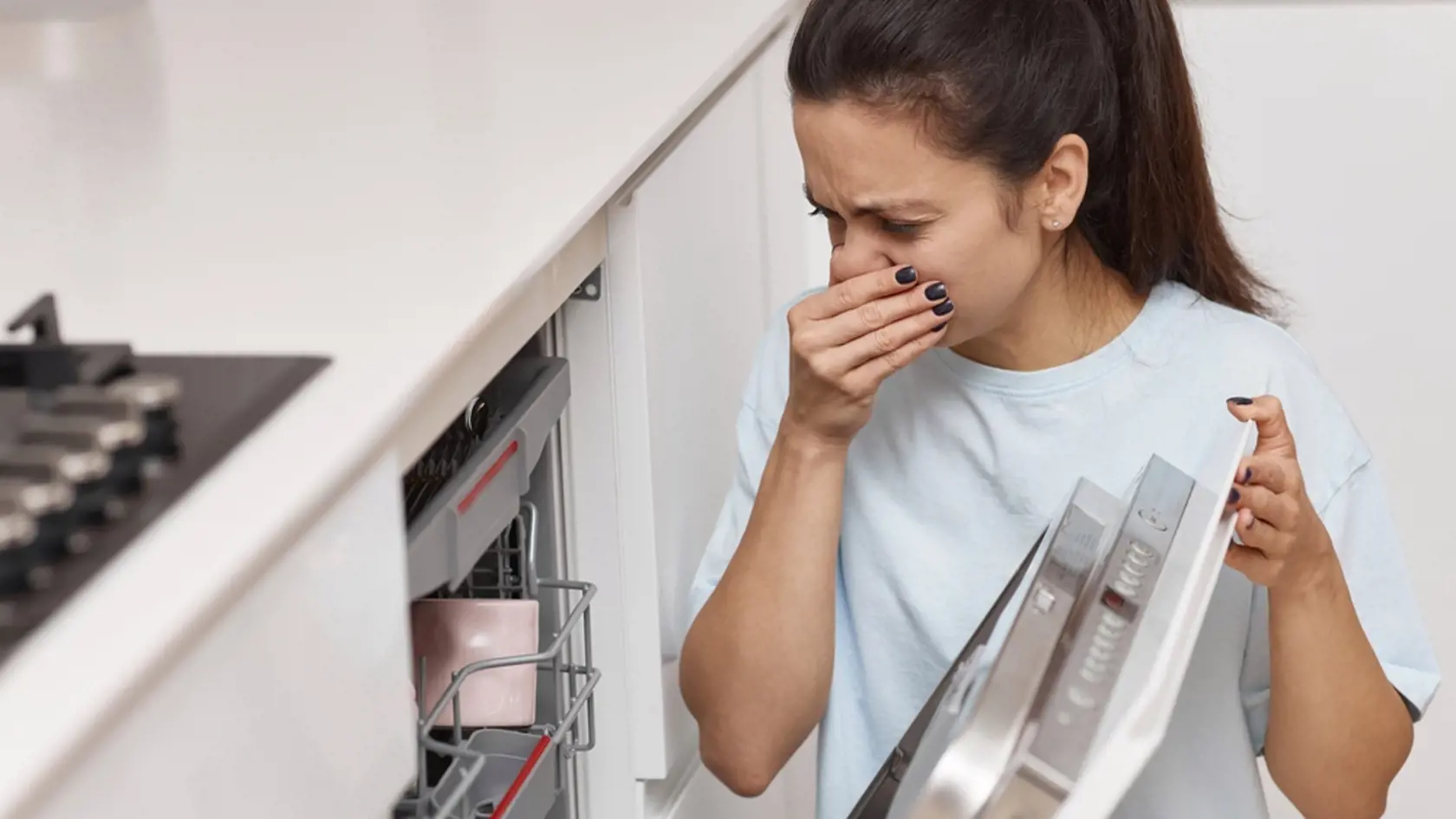Woman,Smells,Strange,And,Terrible,Smell,Coming,From,Dishwasher,Machine
