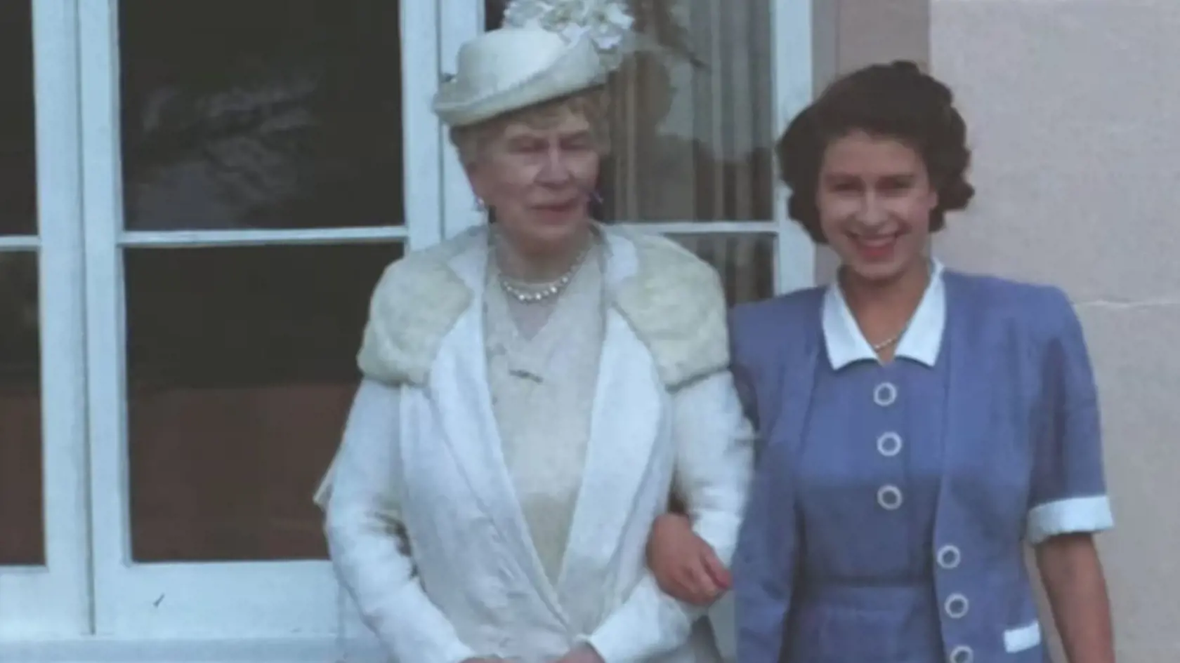 Kráľovná Mary a princezná Alžbeta stoja vedľa seba a pózujú pred kamerou.