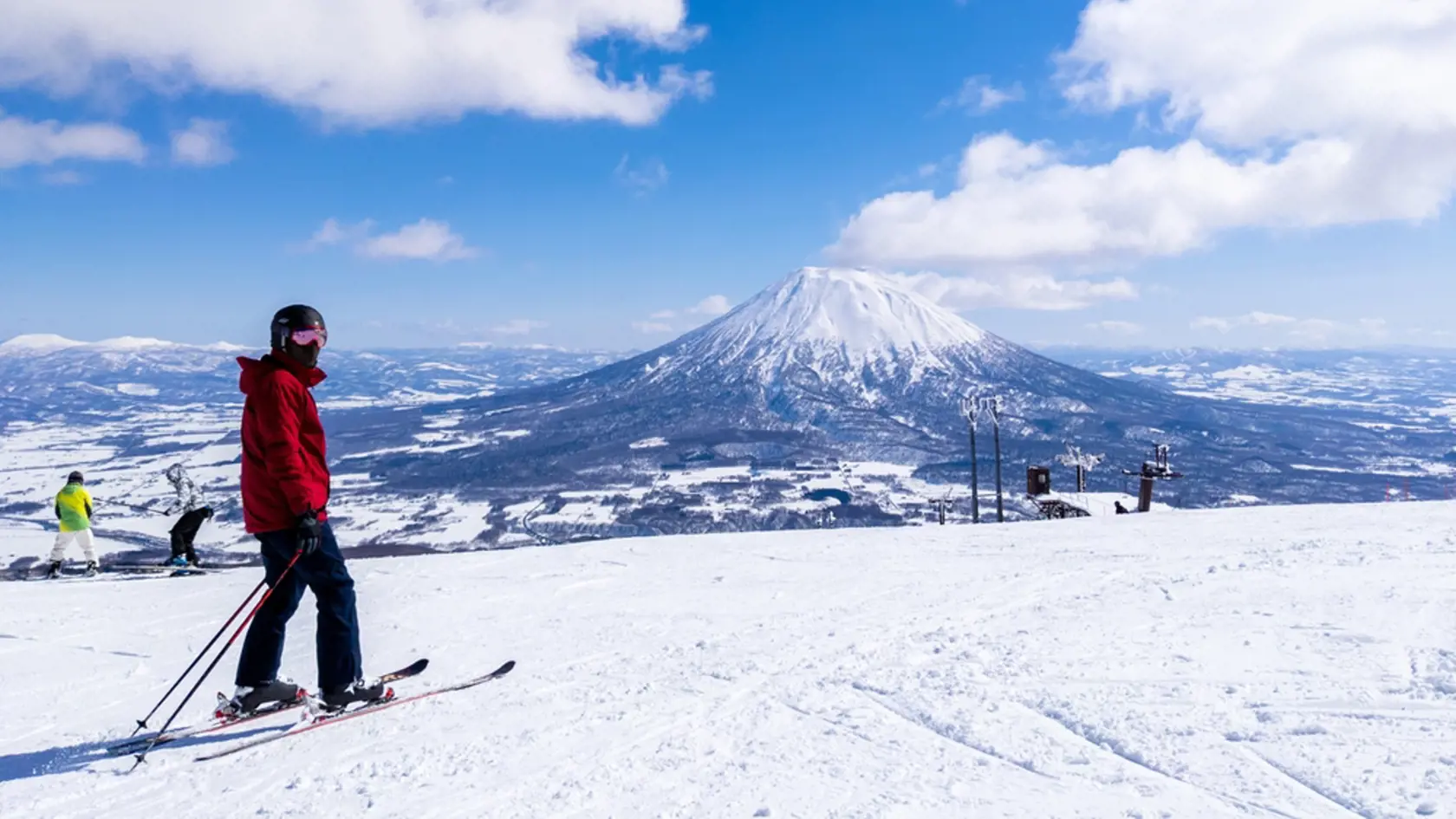 Skier with a snowy volcano (Niseko, Hokkaido, Japan)