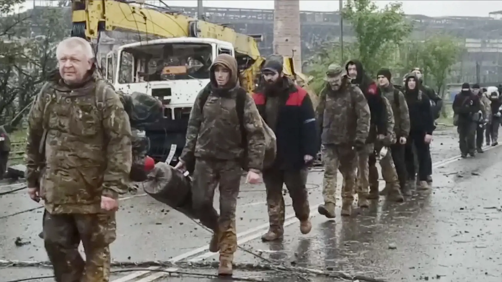 WA 24 Mariupol - Na videosnímke ruského ministerstva obrany vydanej vo štvrtok 19. mája 2022, ukrajinskí vojaci, ktorí niekoľko týždňov odolávali útokom ruských síl v oceliarniach Azovstaľ, kráčajú po ceste pred závodom ocelarní v juhoukrajinskom prístavnom meste Mariupol. FOTO TASR/AP 

 
Ukrainian servicemen sit in a bus traveling from Mariupol to a prison in Olyonivka after they leave the besieged Mariupol's Azovstal steel plant, in Mariupol, in territory under the government of the Donetsk P