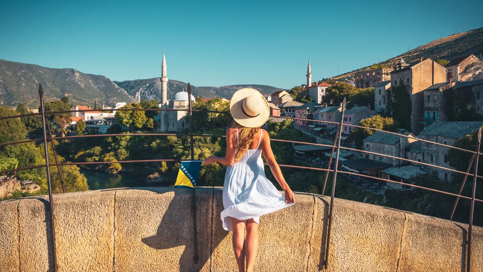 Woman,In,White,Dress,Looking,At,Old,Mosque,In,Town