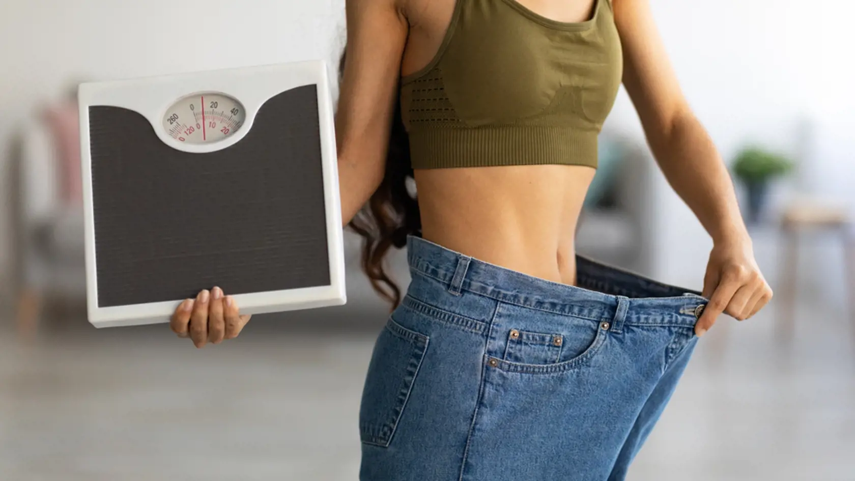 Unrecognizable,Indian,Woman,In,Oversized,Jeans,Holding,Scales,,Showing,Results