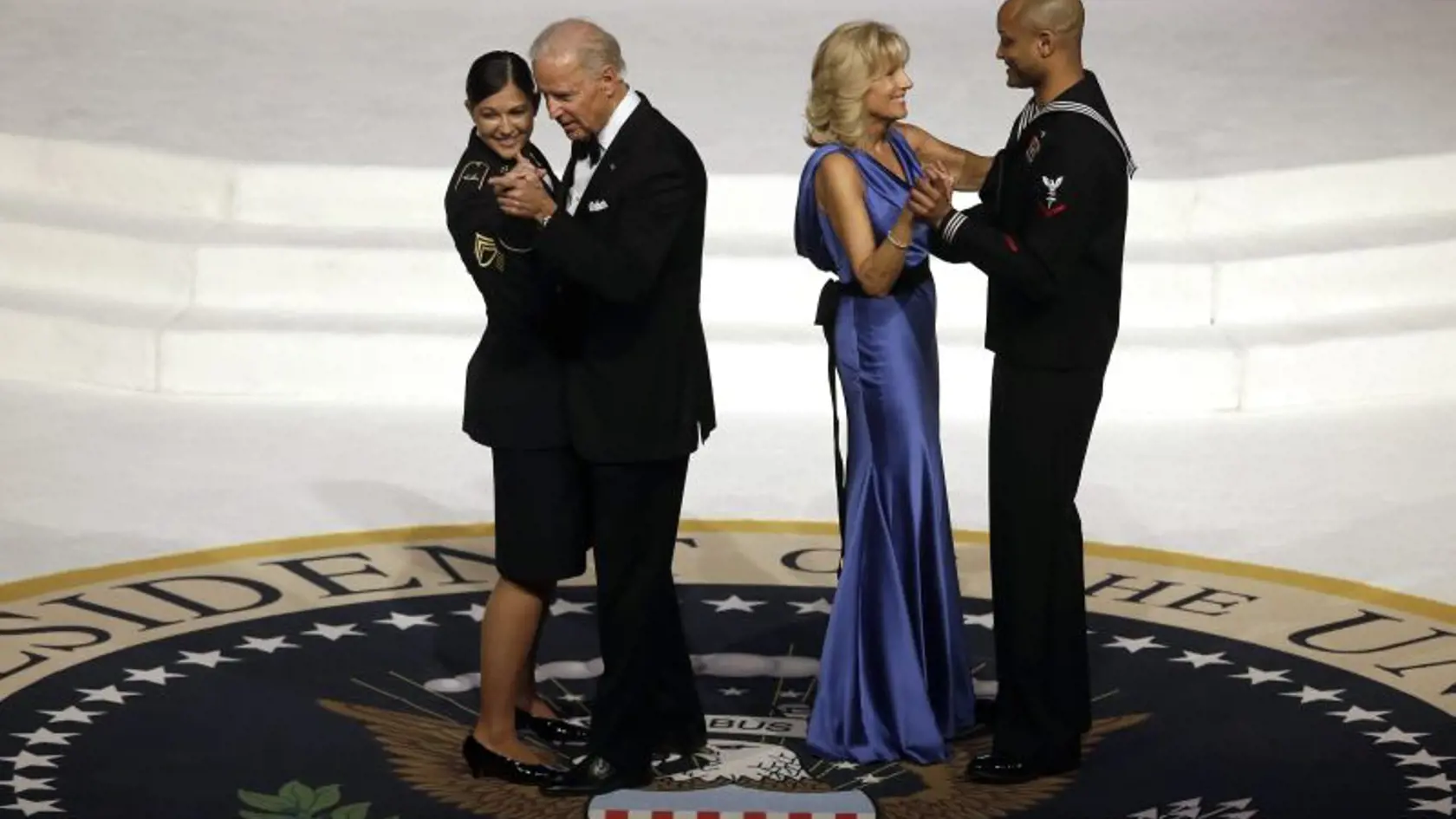 Vice President Joe Biden dances with Army Staff Sgt. Keesha Dentino as Jill Biden dances with Navy Petty Officer 3rd Class Patrick Figueroa during the Commander-In-Chief inaugural ball at the Washington Convention Center during the 57th Presidential Inauguration Monday, Jan. 21, 2013 in Washington.  (AP Photo/ Evan Vucci)