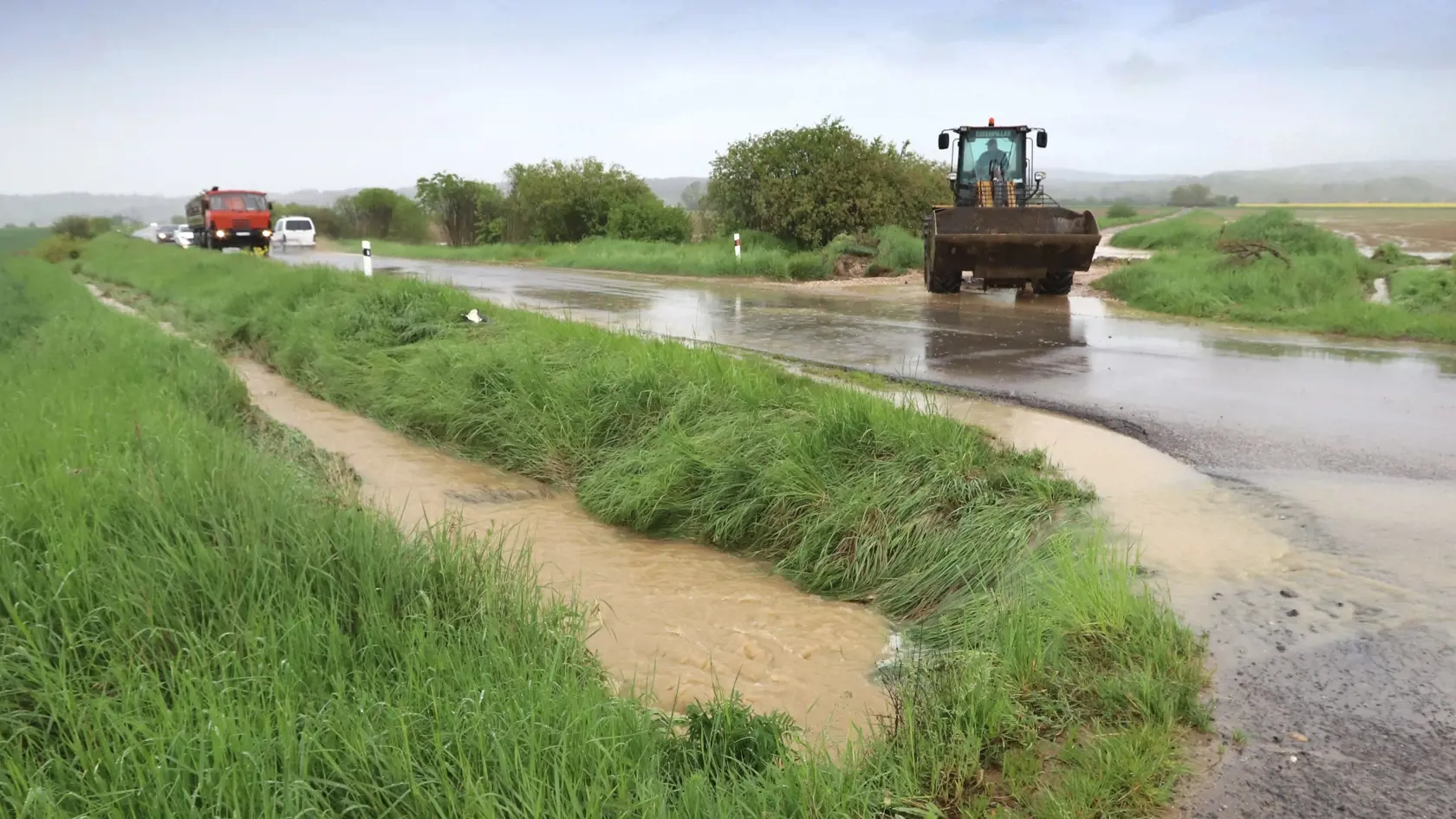 Na väčšine územia Slovenska platia až do stredy výstrahy pred dažďom prvého a druhého stupňa. Slovenský hydrometeorologický ústav (SHMÚ) varuje aj pred povodňami, najmä na západnom a strednom Slovensku. Na snímke úsek cesty Očová - Dúbrava, kde sa cez cestu valí masívne množstvo vody a blata z okolitých polí. Okres Zvolen, 17. mája 2023. FOTO TASR - Ján Krošlák