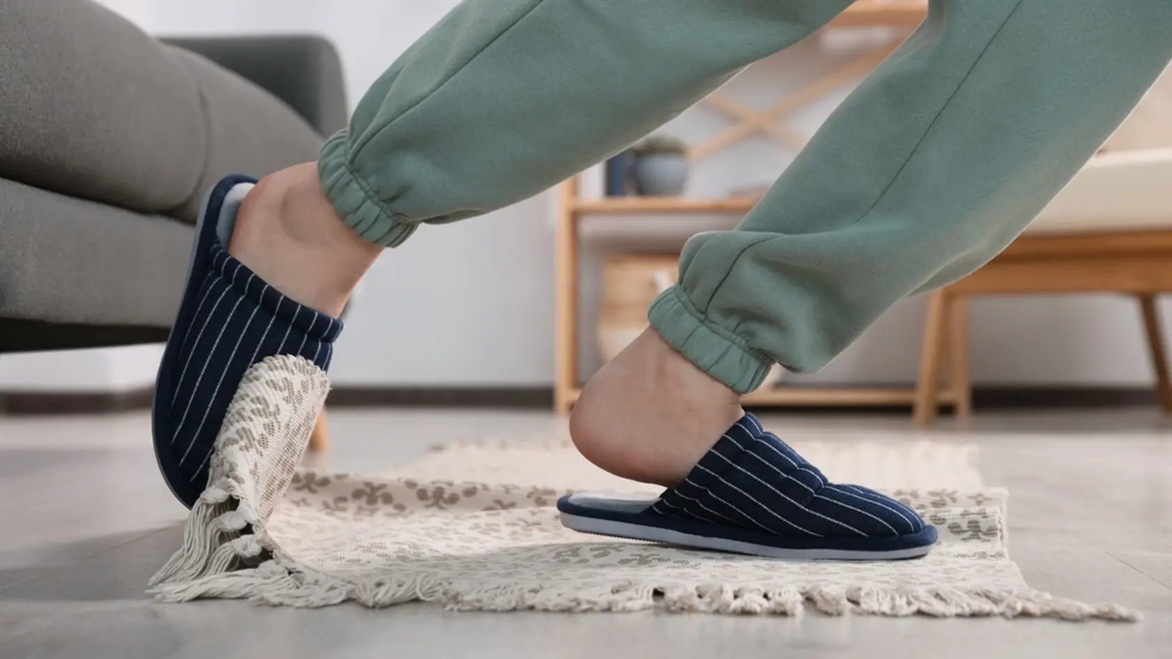 Man tripping over rug at home, closeup