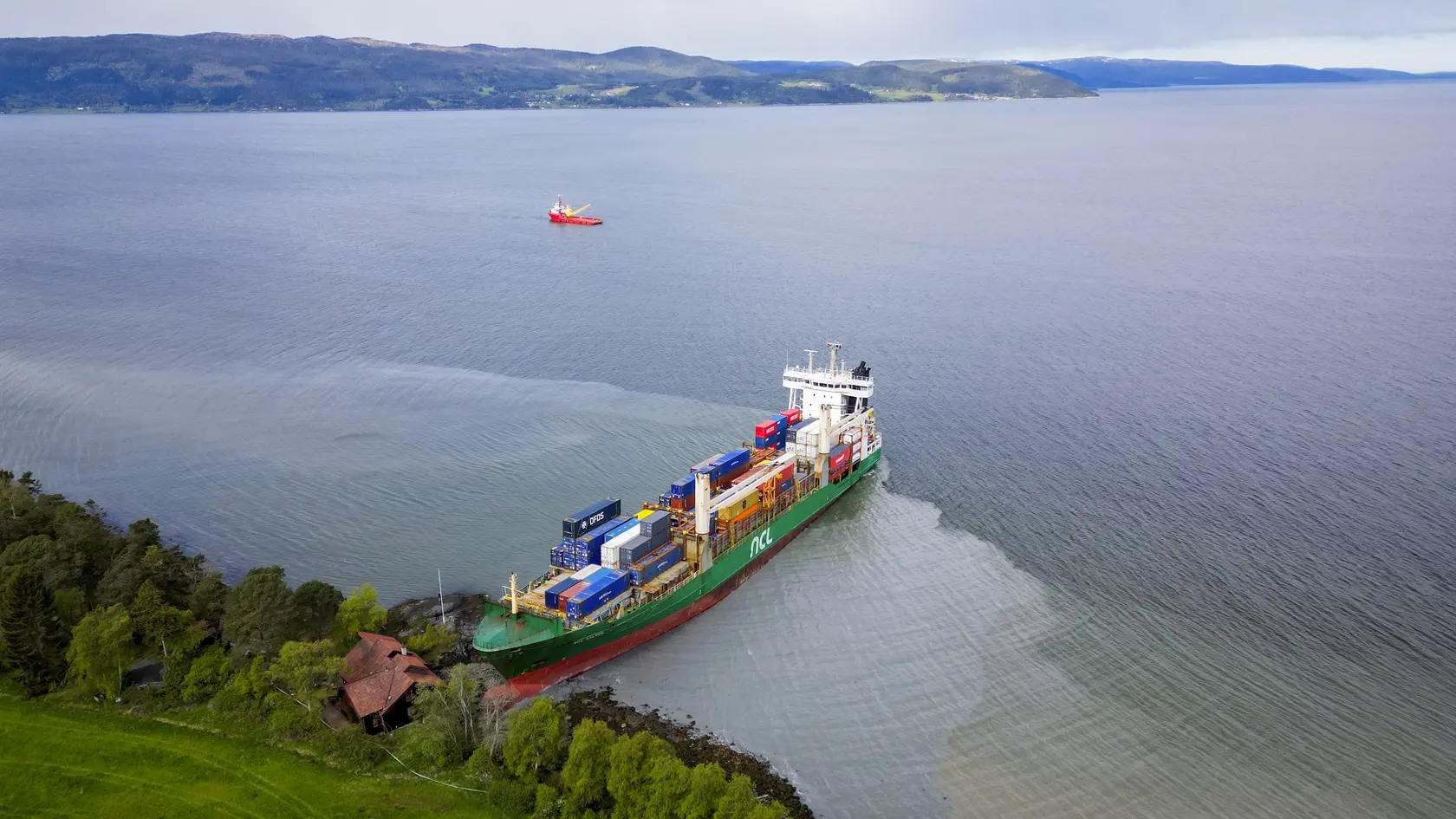 Na snímke kontajnerová loď NCL Salten po tom, ako narazila na plytčinu neďaleko nórskej obce Byneset vo fjorde Trondheimsfjord 22. mája 2025. Nákladná loď narazila do brehu v nórskom fjorde iba niekoľko metrov od domu, kde v tom čase spal muž. Johana Helbera prebudil až sused, ktorý prišiel skontrolovať, či je v poriadku.